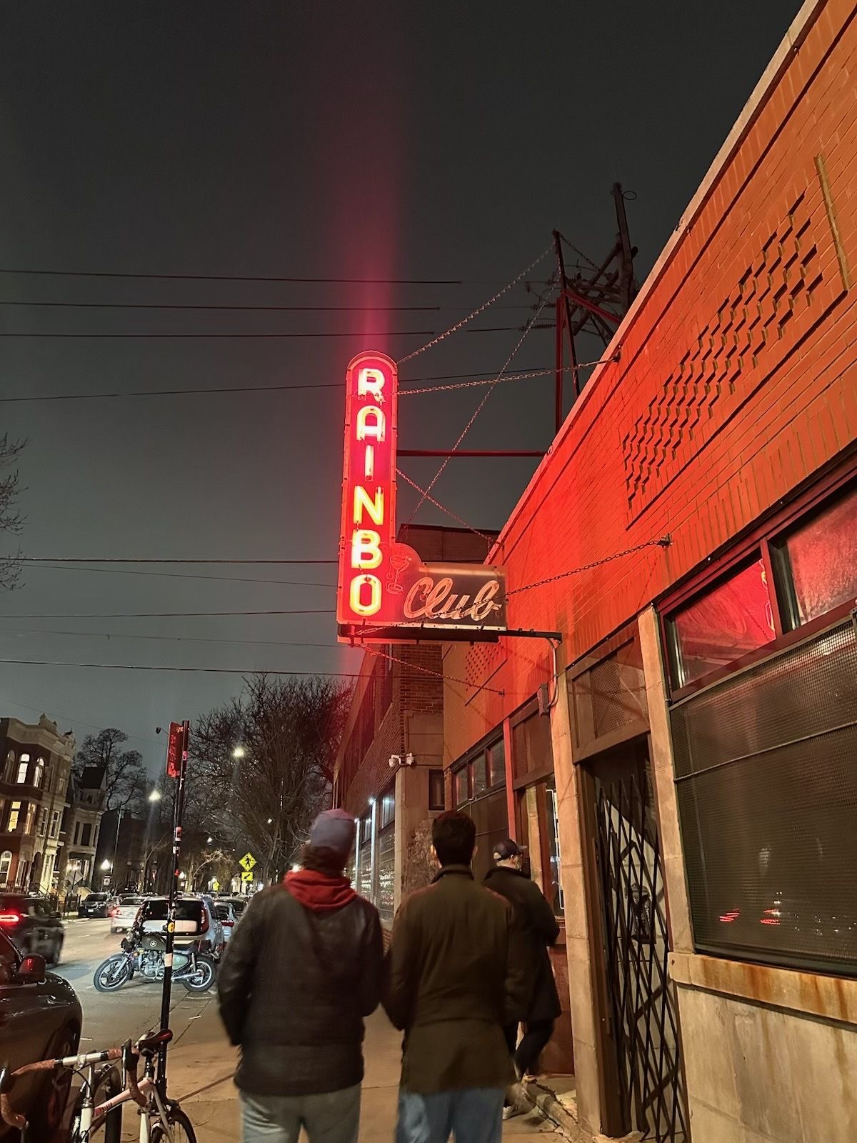 A photo of a sign that is lit us and says "Rainbo Club"