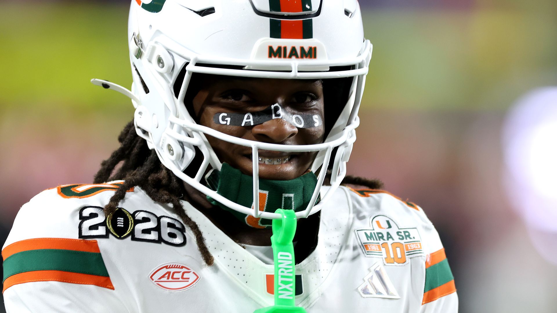 Close up photo of Malachi Toney with eye-back that says GABOS. He's wearing Miami Hurricanes helmet and white jersey during the 2026 national championship game.