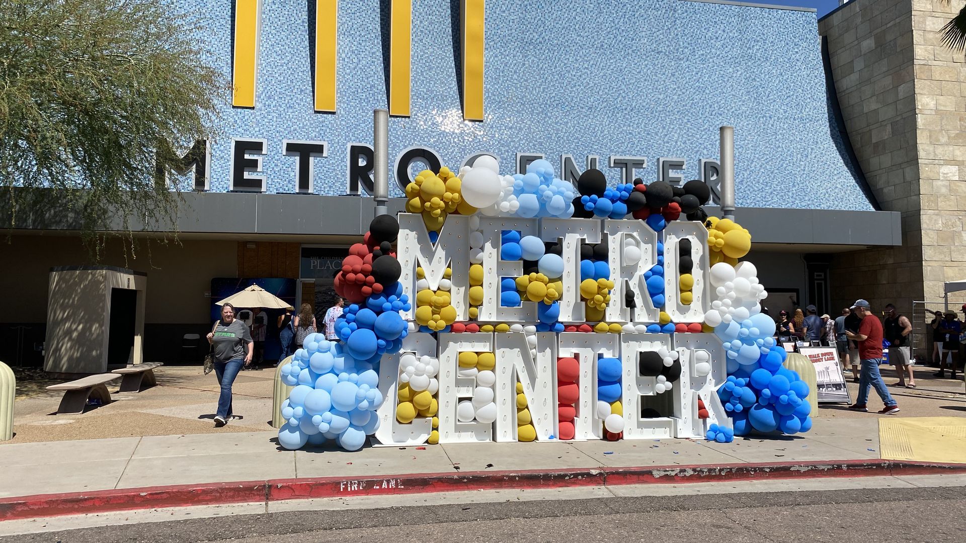 The shuttered entrance of a mall with the words a balloon-covered display featuring the words Metro Center.