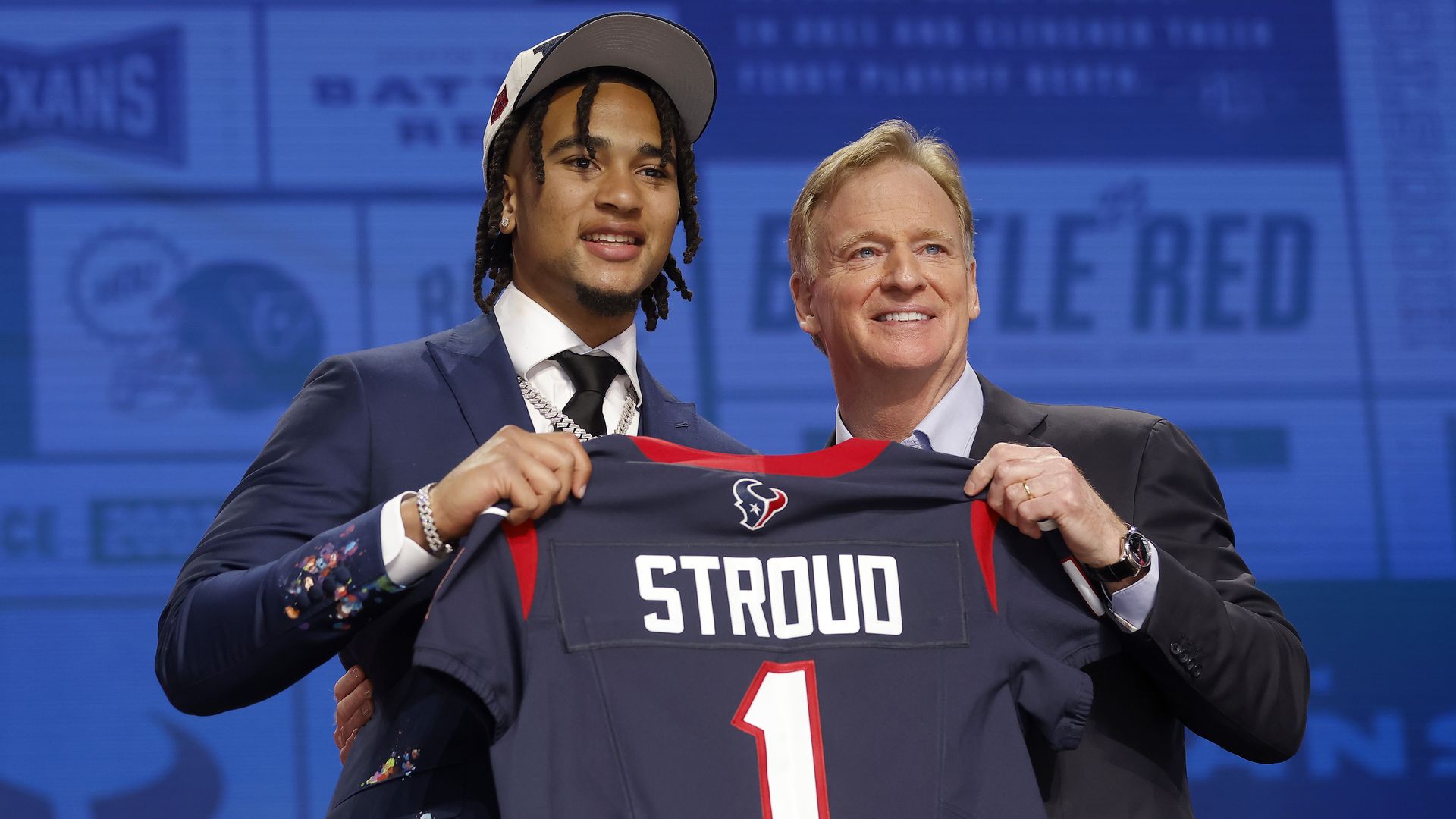 C.J. Stroud and NFL Commissioner Roger Goodell hold a Texans jersey and pose for a photo 