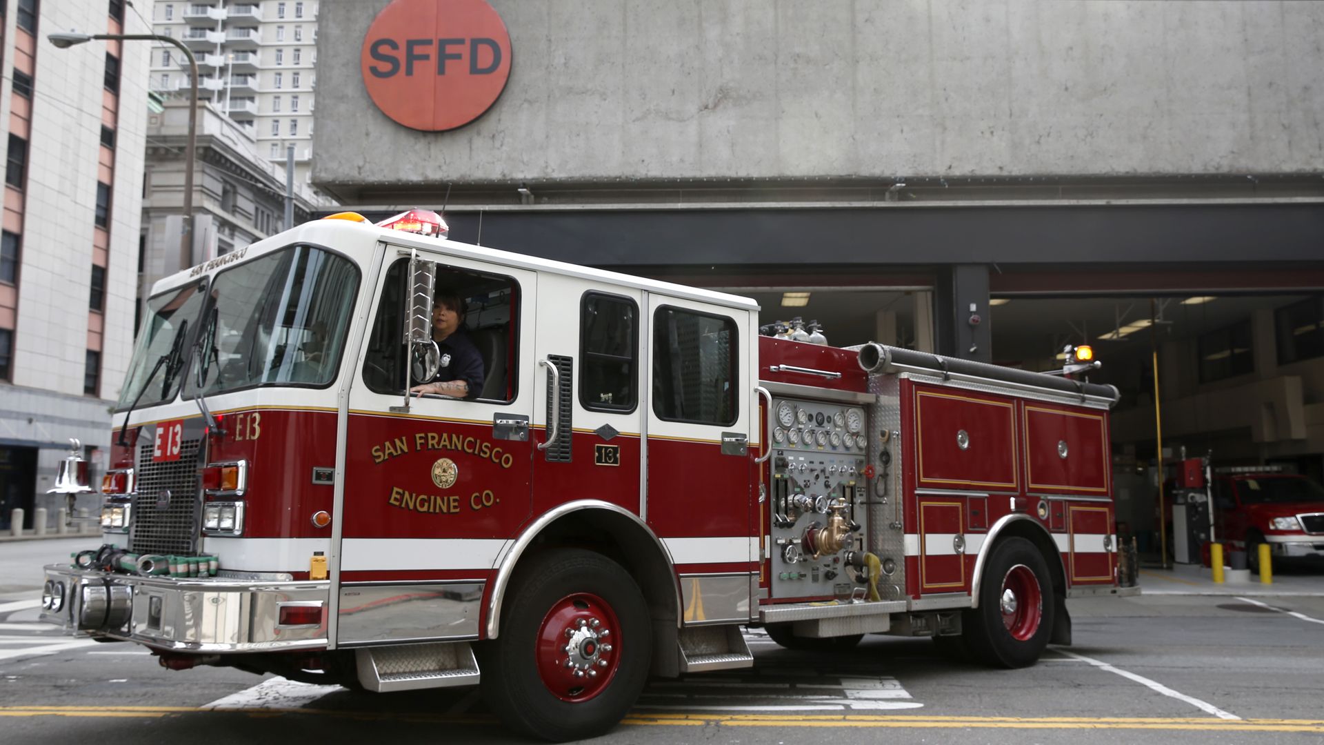 Photo of a red San Francisco fire truck in front of the SFFD station