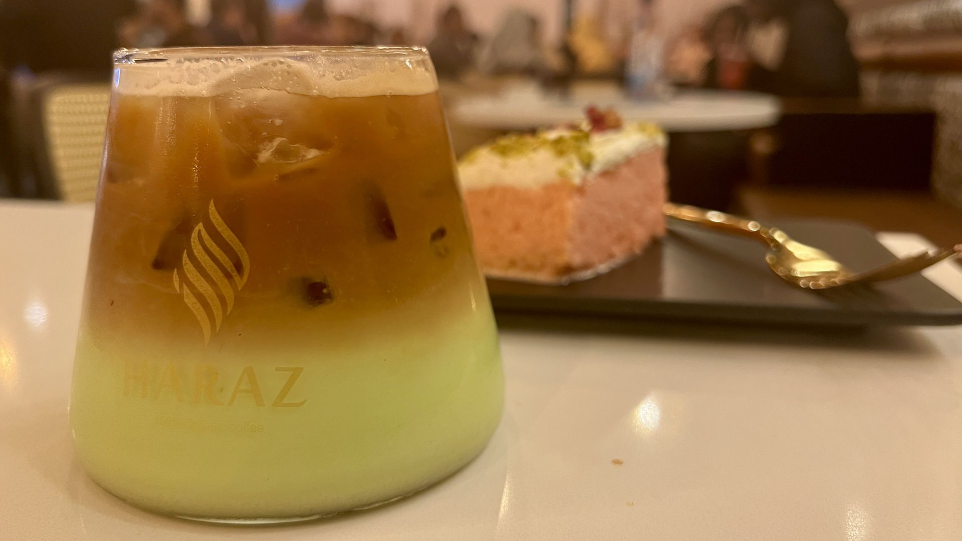 A clear glass with a green latte