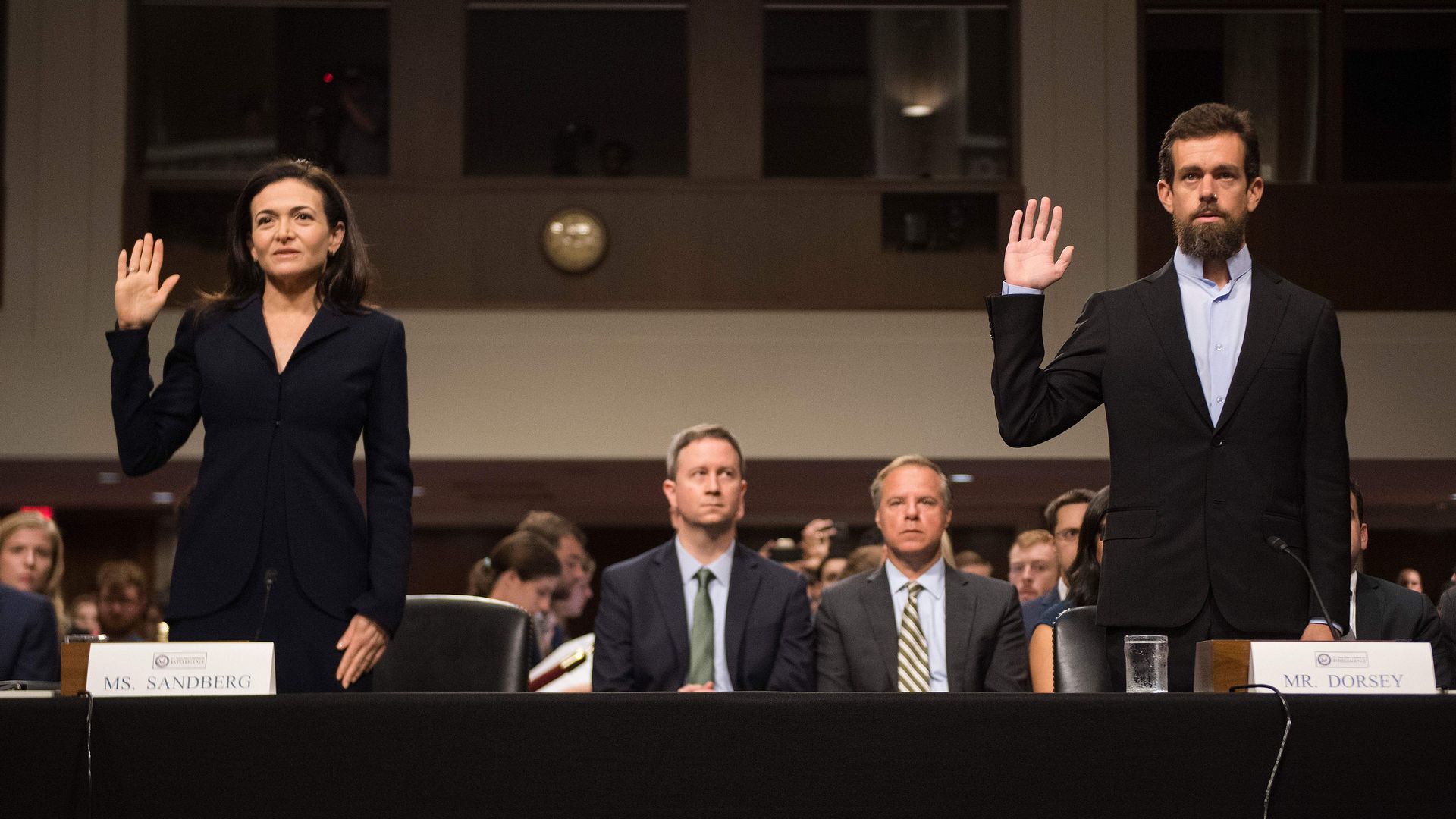 Sheryl Sandberg and Jack Dorsey being sworn in