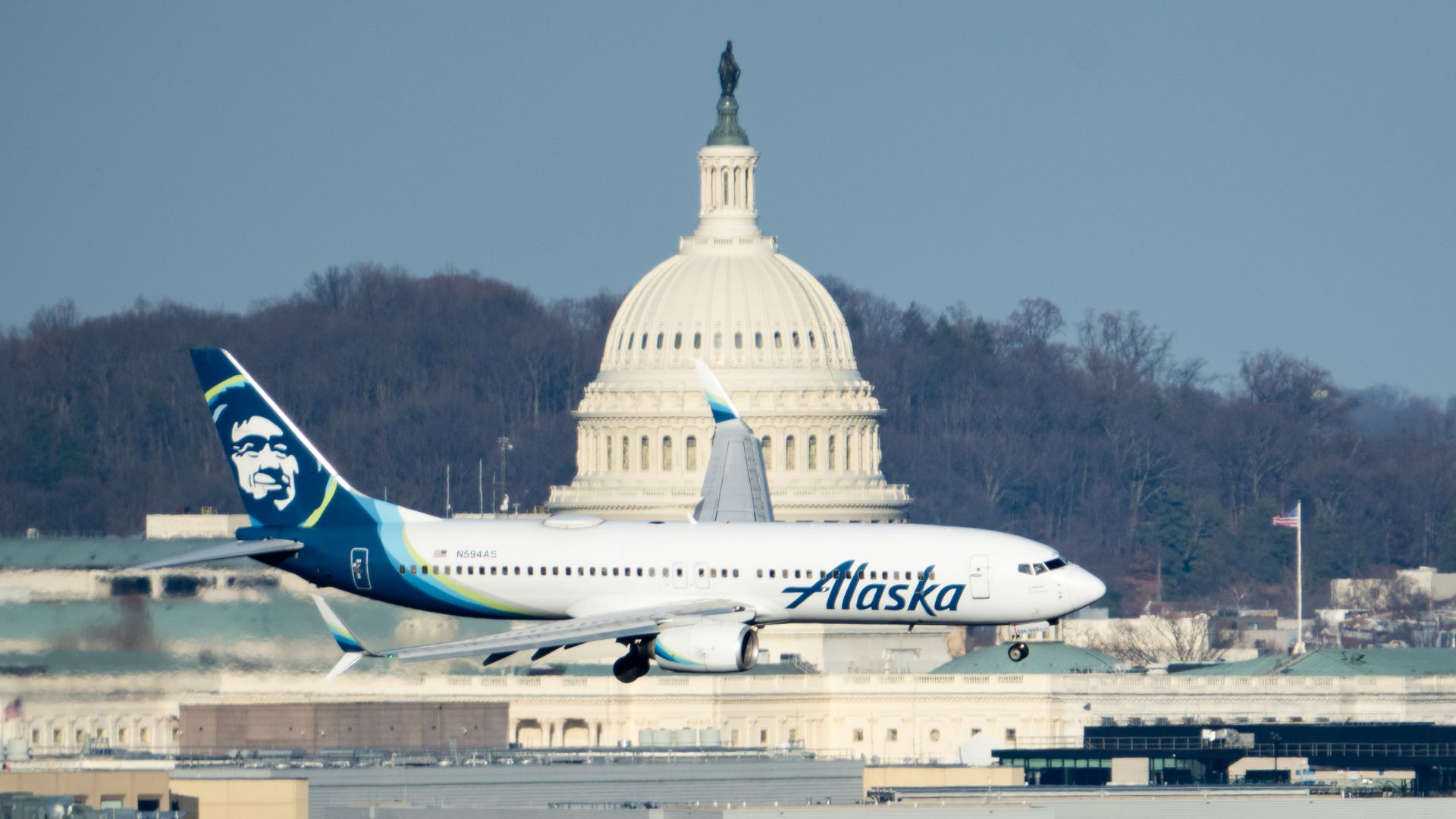 An Alaska Airlines plane flies in front of the U.S. Capitol dome 