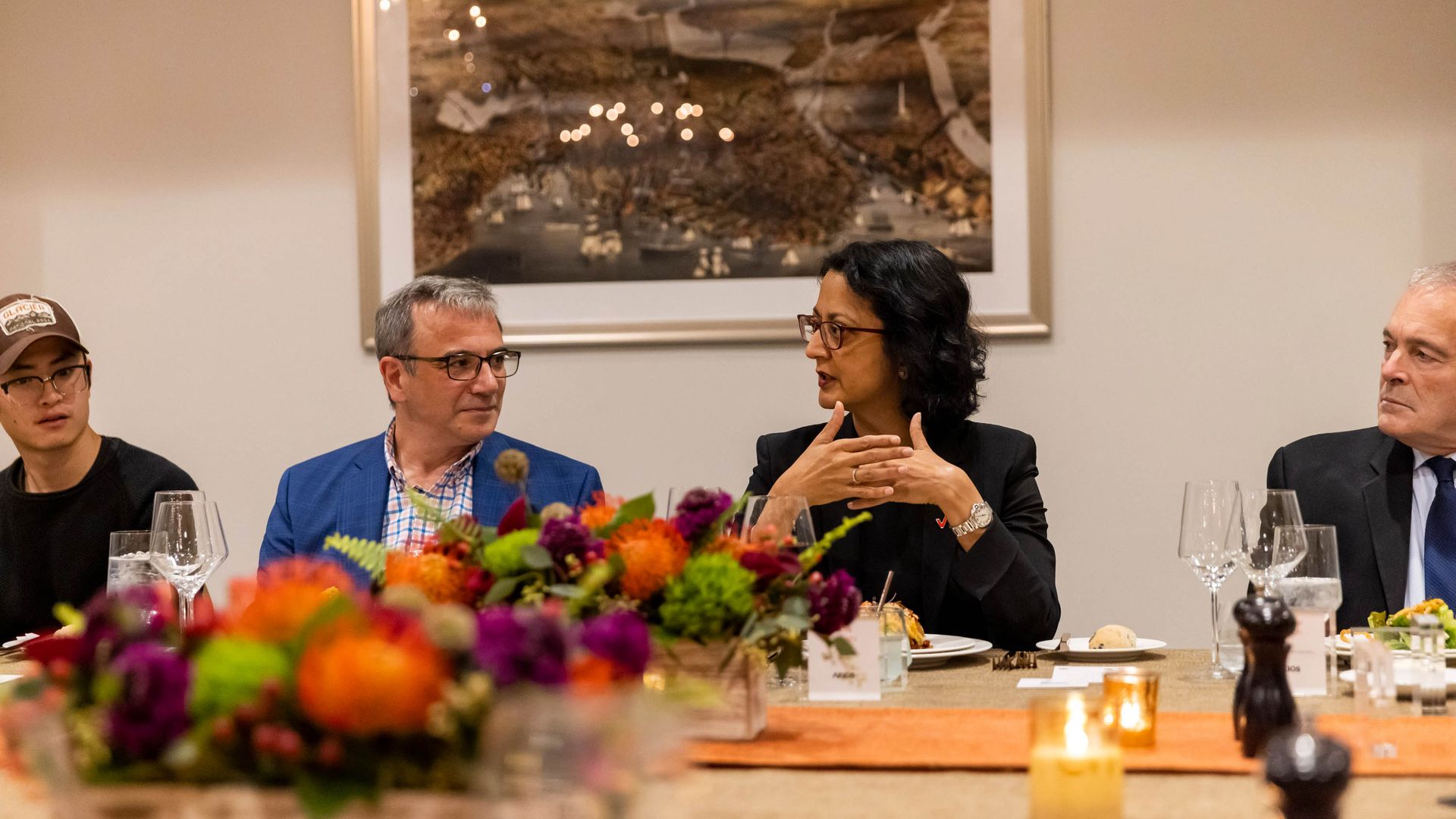 Rima Qureshi, Chief Strategy Officer at Verizon, sits at the Axios table between Aaron Pressman, left, and Michael Helfrich. 