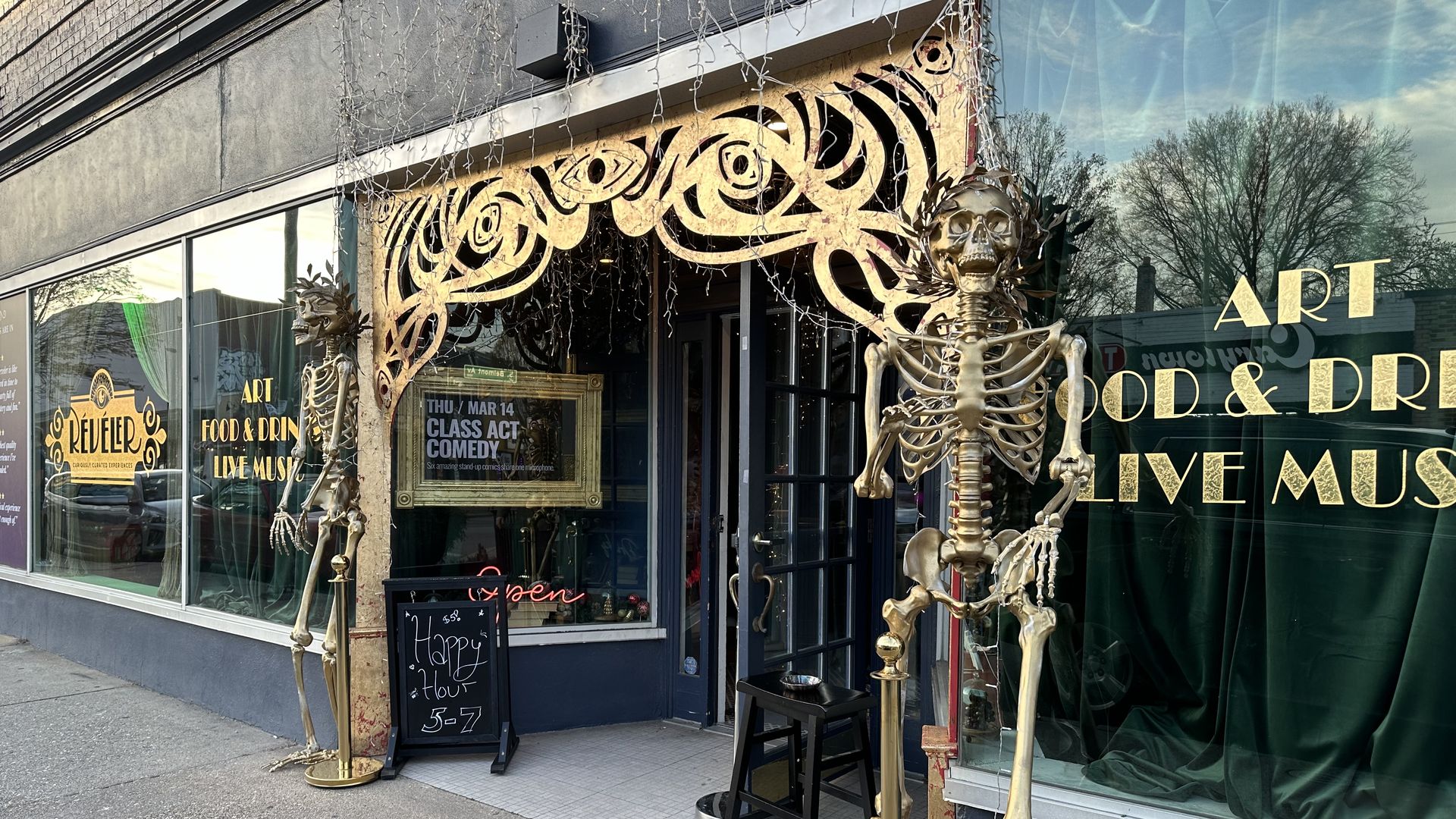 the outside of a building with golden skeletons and gold trim 