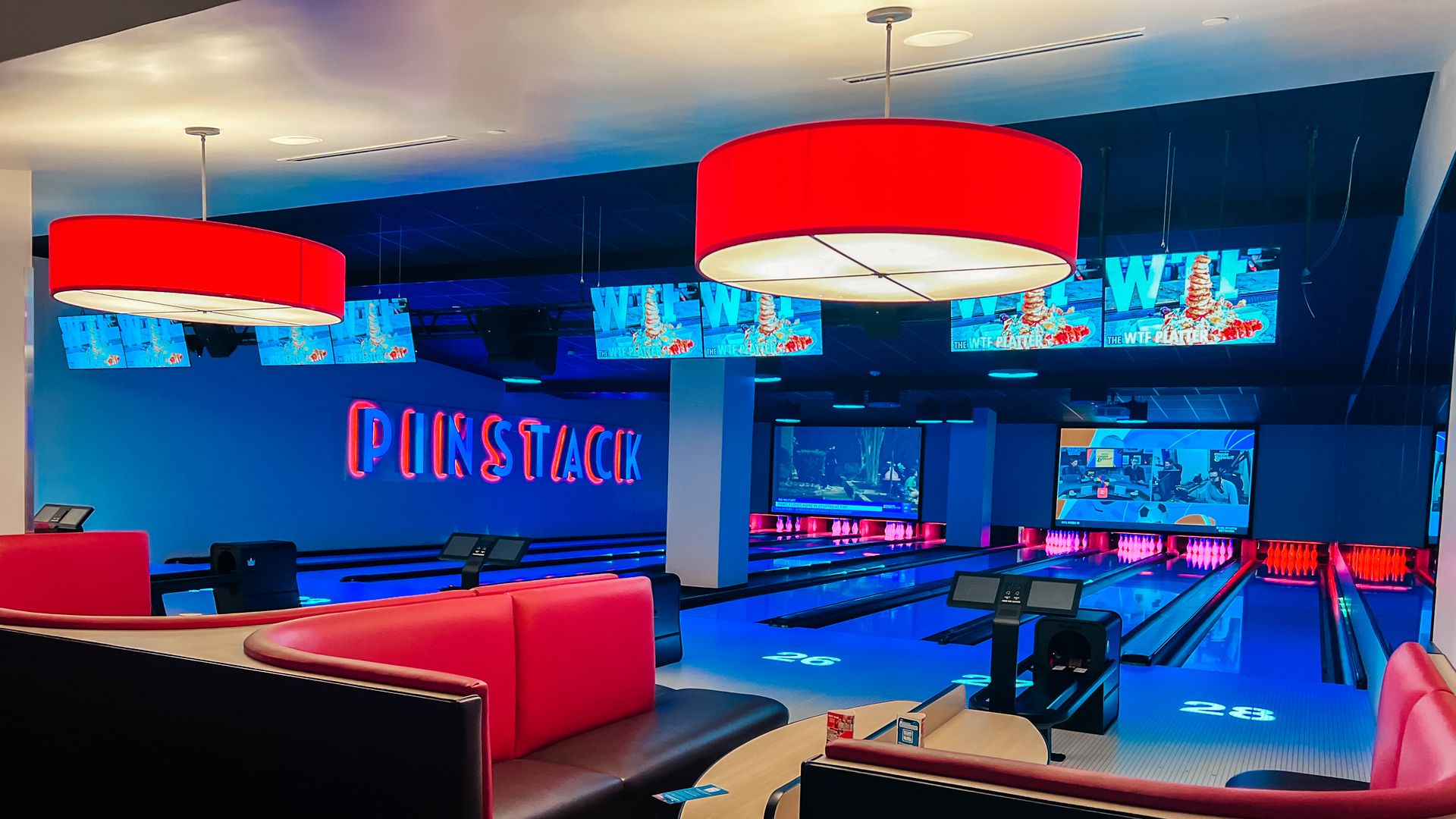 Pinstack's bowling alleys illuminated with blue lights. 