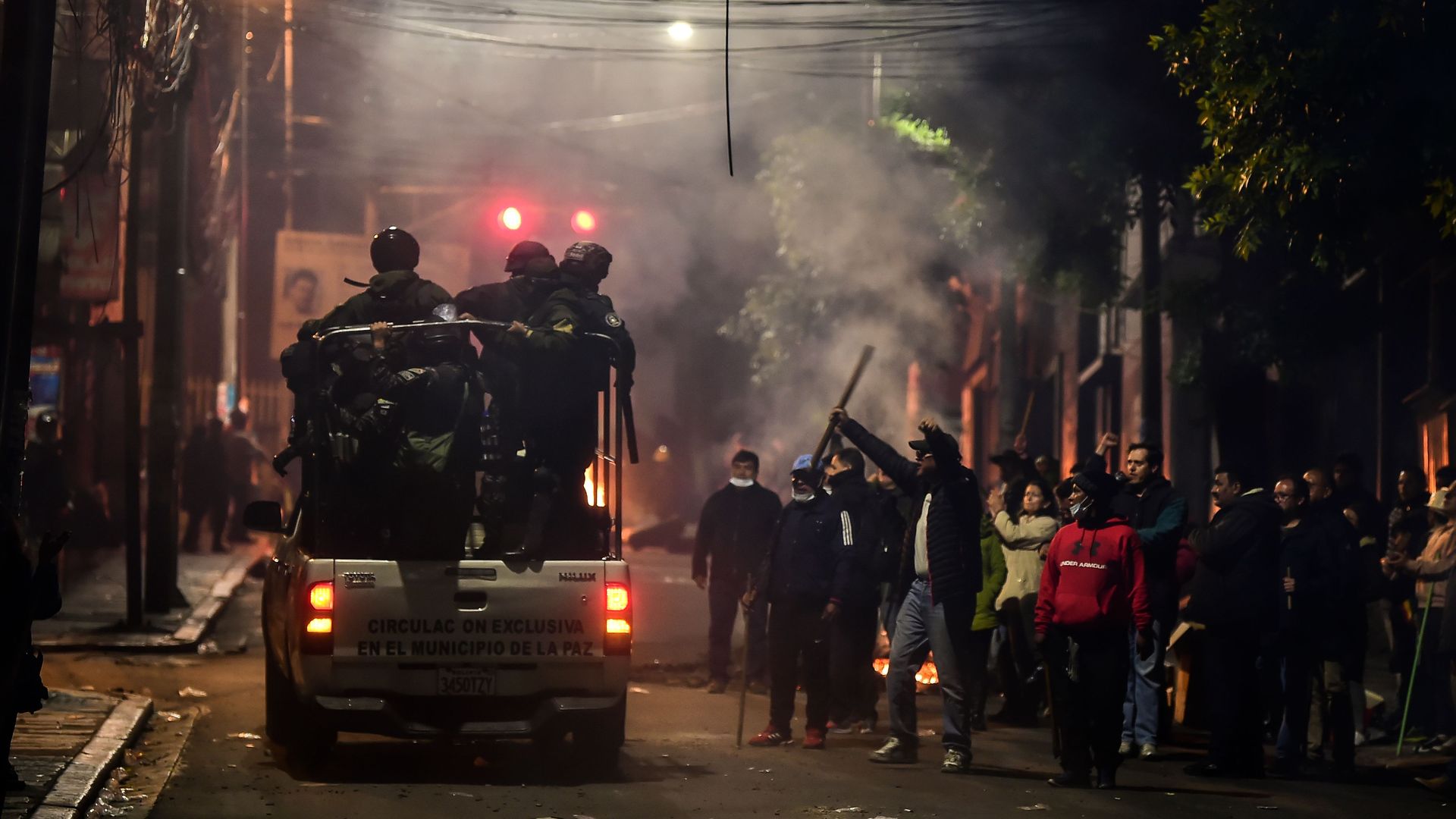 People gesture at policemen as they patrol the streets in La Paz, Bolivia on November 11