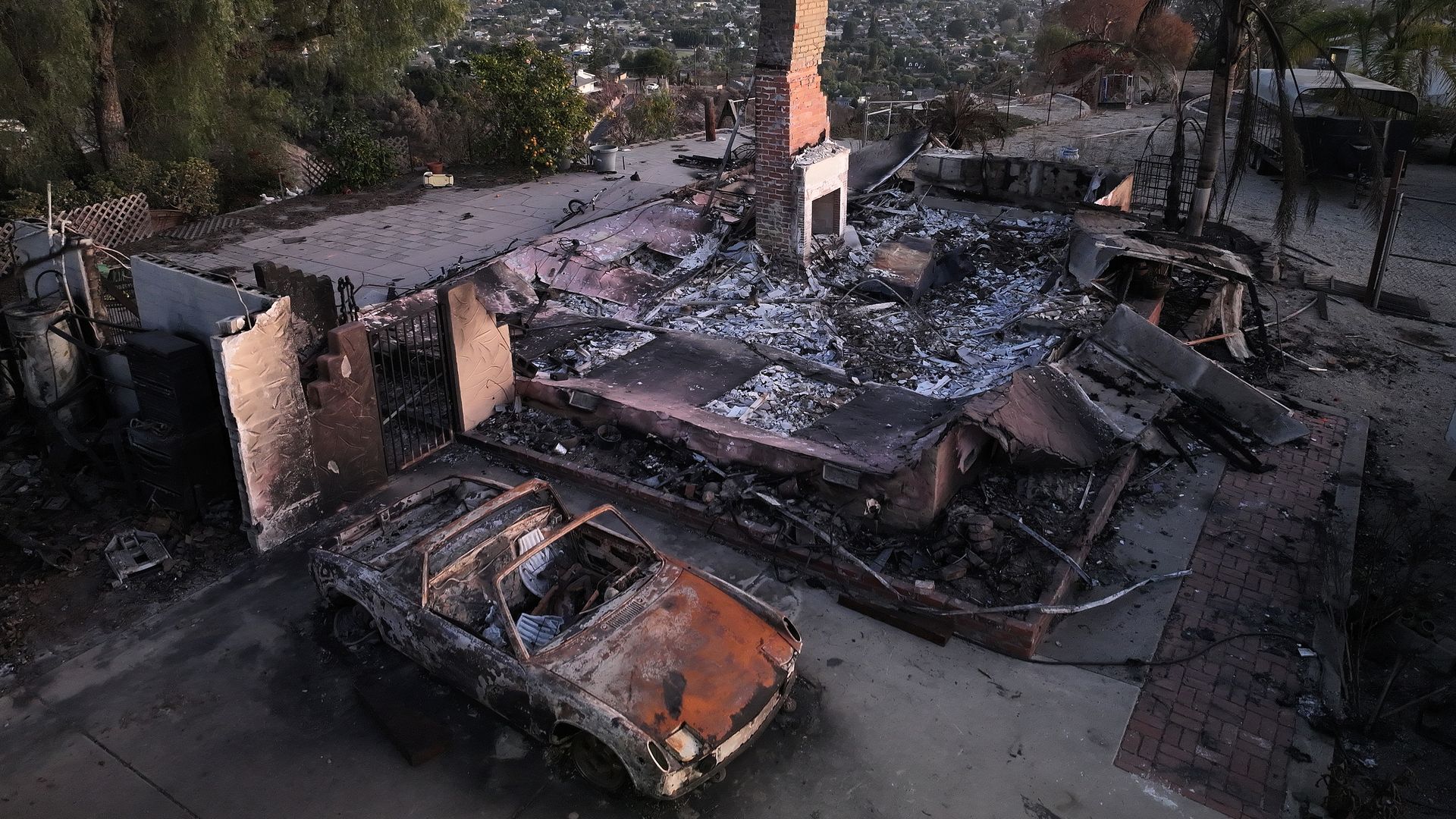A photo from above of a home and car that were destroyed in the Mountain Fire in Southern California in November 2024.