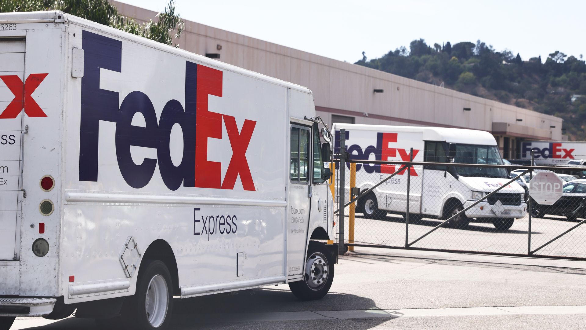 FedEx trucks are parked at a FedEx Ship Center on September 22, 2021 in Los Angeles, California. 