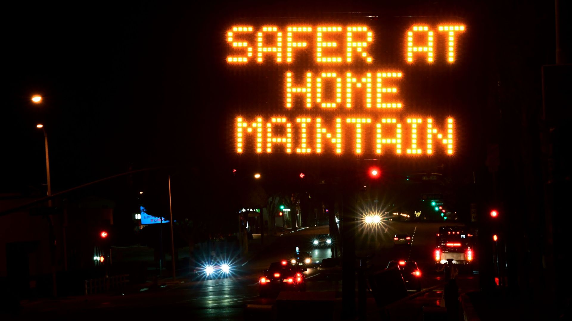 A sign reading "safer at home"