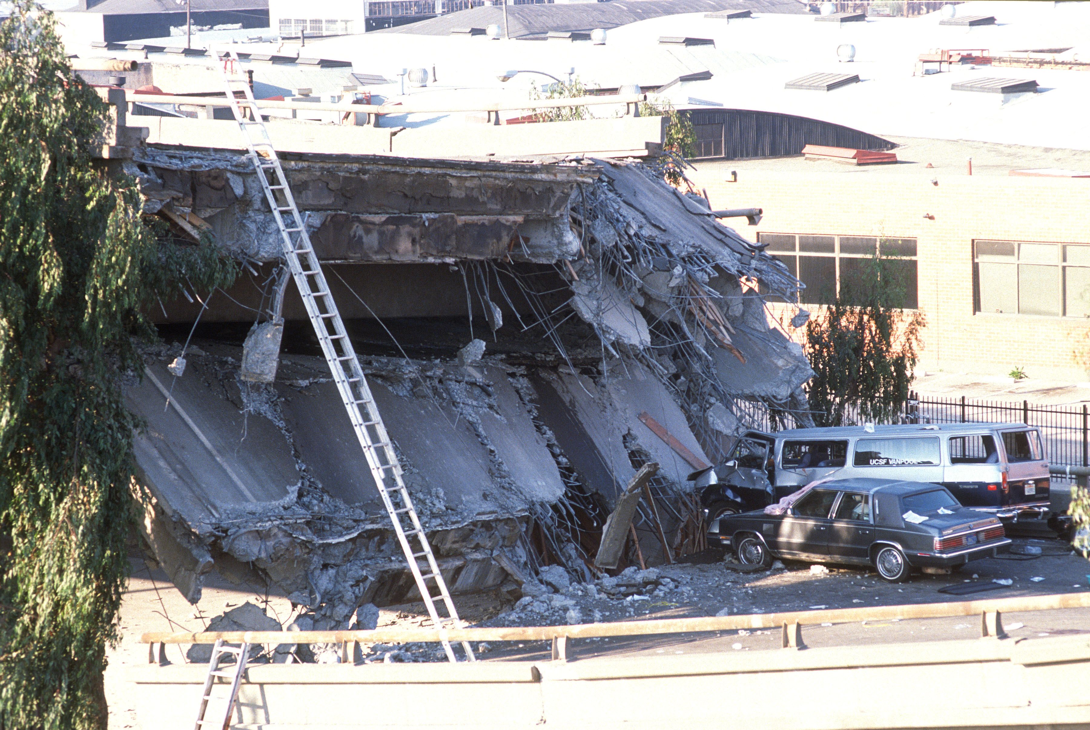 Photo of a freeway collapsed onto the bottom road and crushing cars