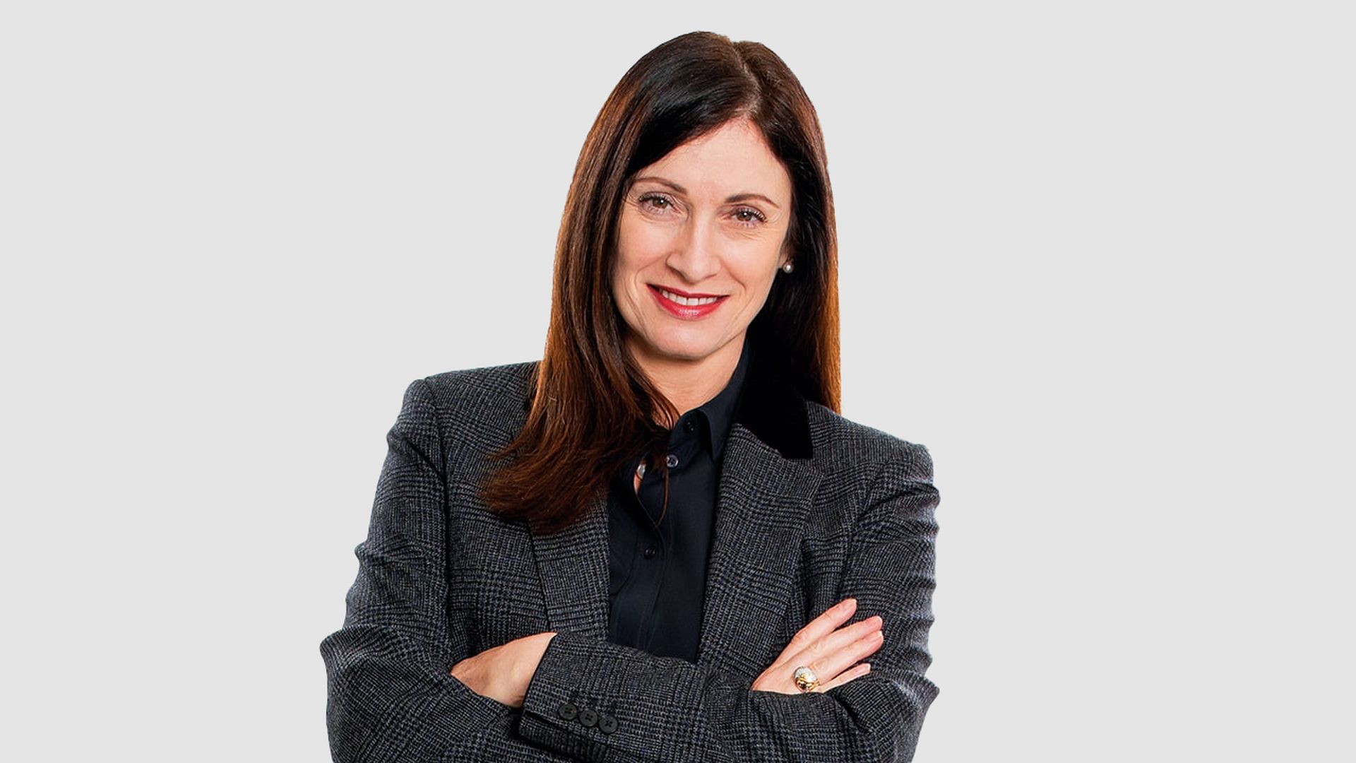 Headshot of Cindy Rose, wearing a blazer with her arms crossed