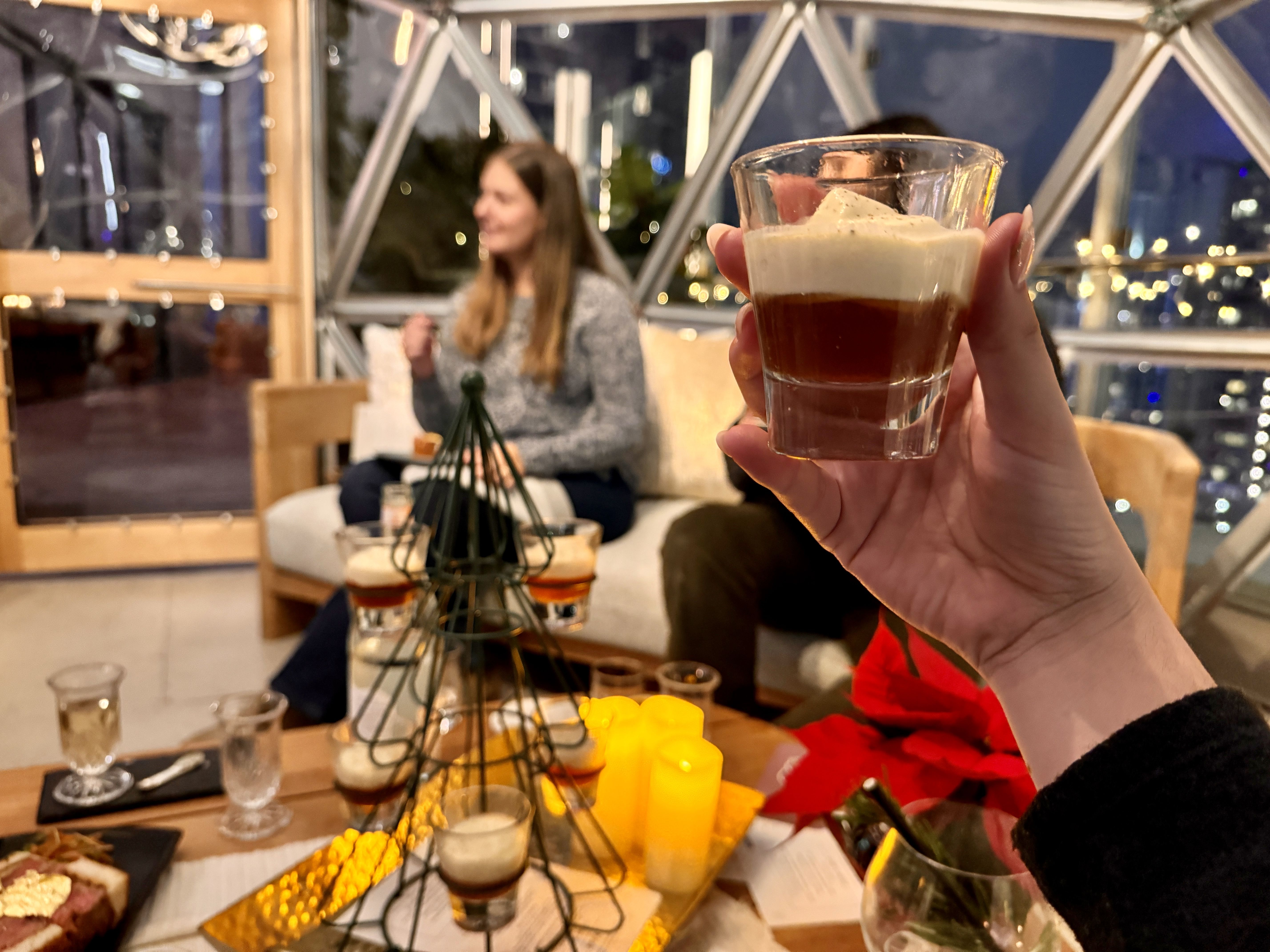 hand holding small cocktail glass