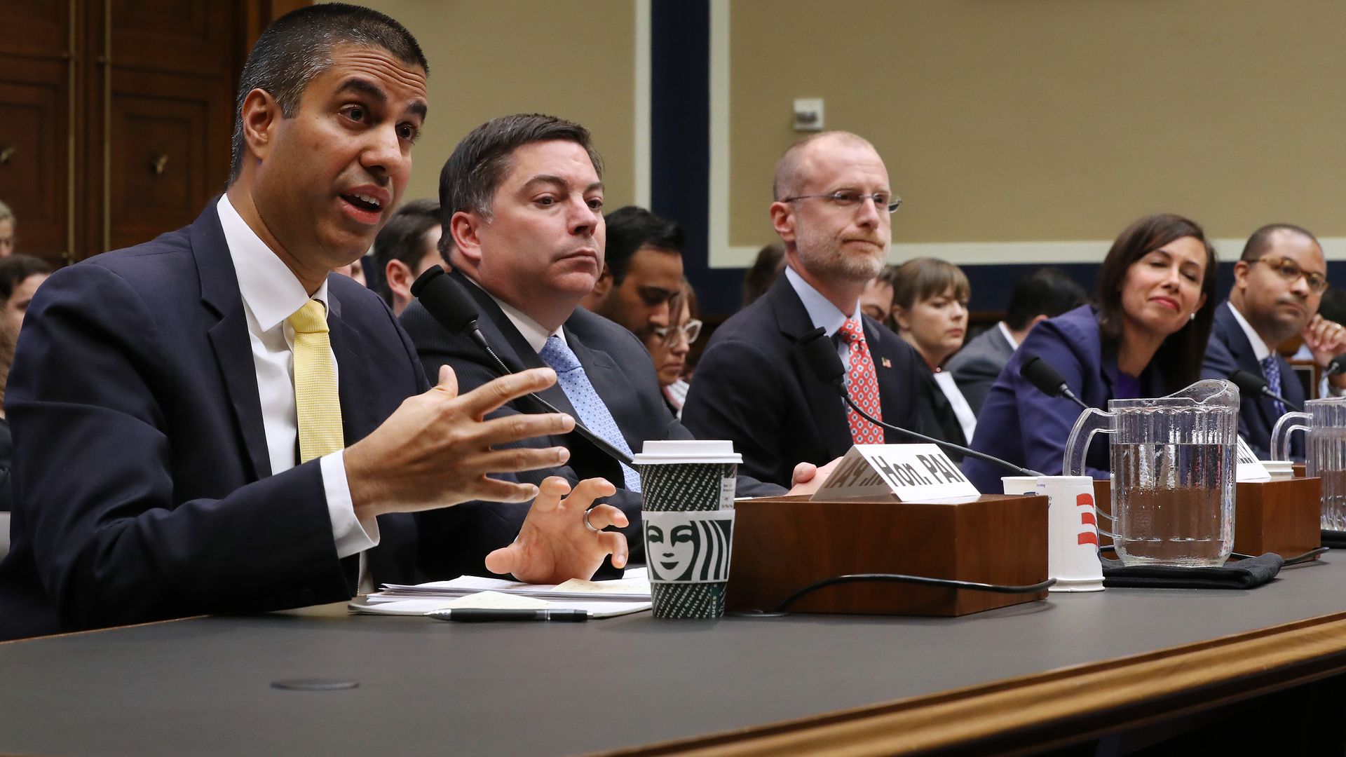 Photo of FCC members at a House hearing with chairman Ajit Pai at far left
