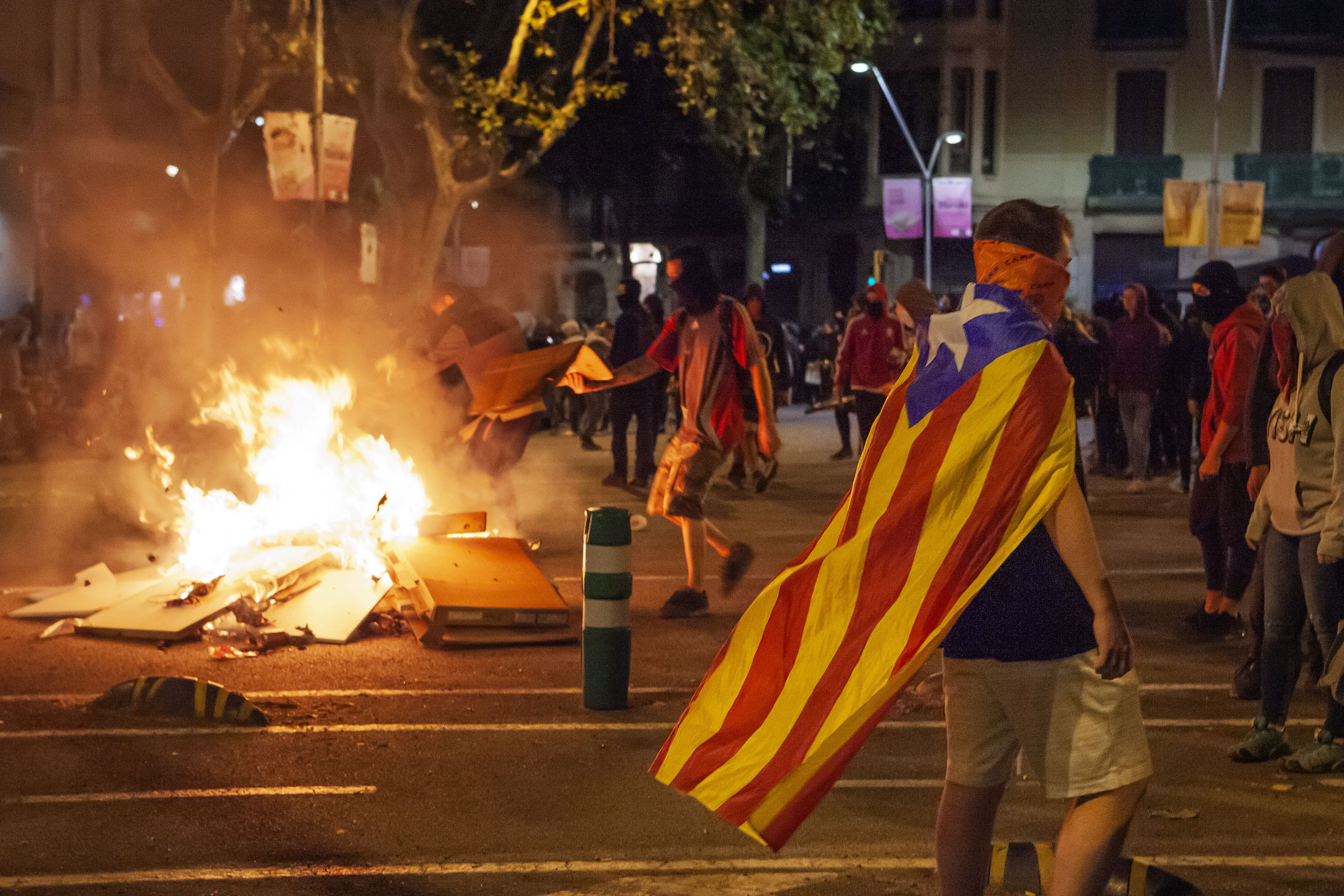 Protestors clash against Spanish police forces in the streets of Barcelona over the third day of protests