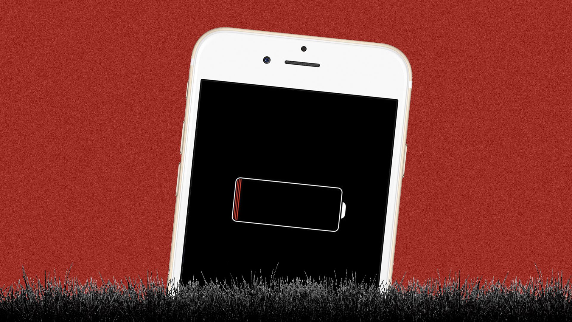 A smart phone disappearing into the grass