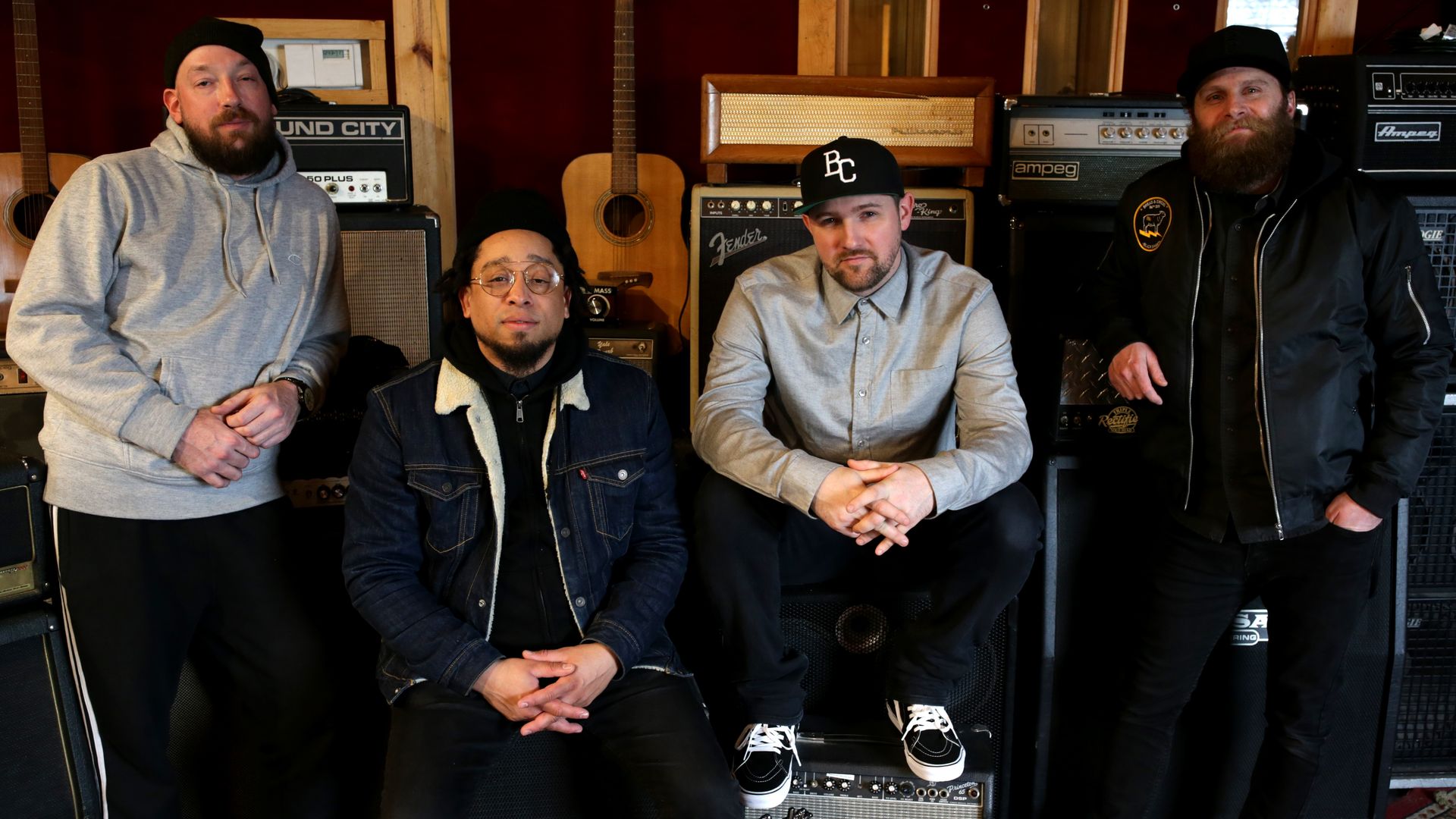 Christopher Talken, Moe Pope, The Arcitype and Jonathan Ulman (left to right) of STL GLD pose for a photo in front of some amps.