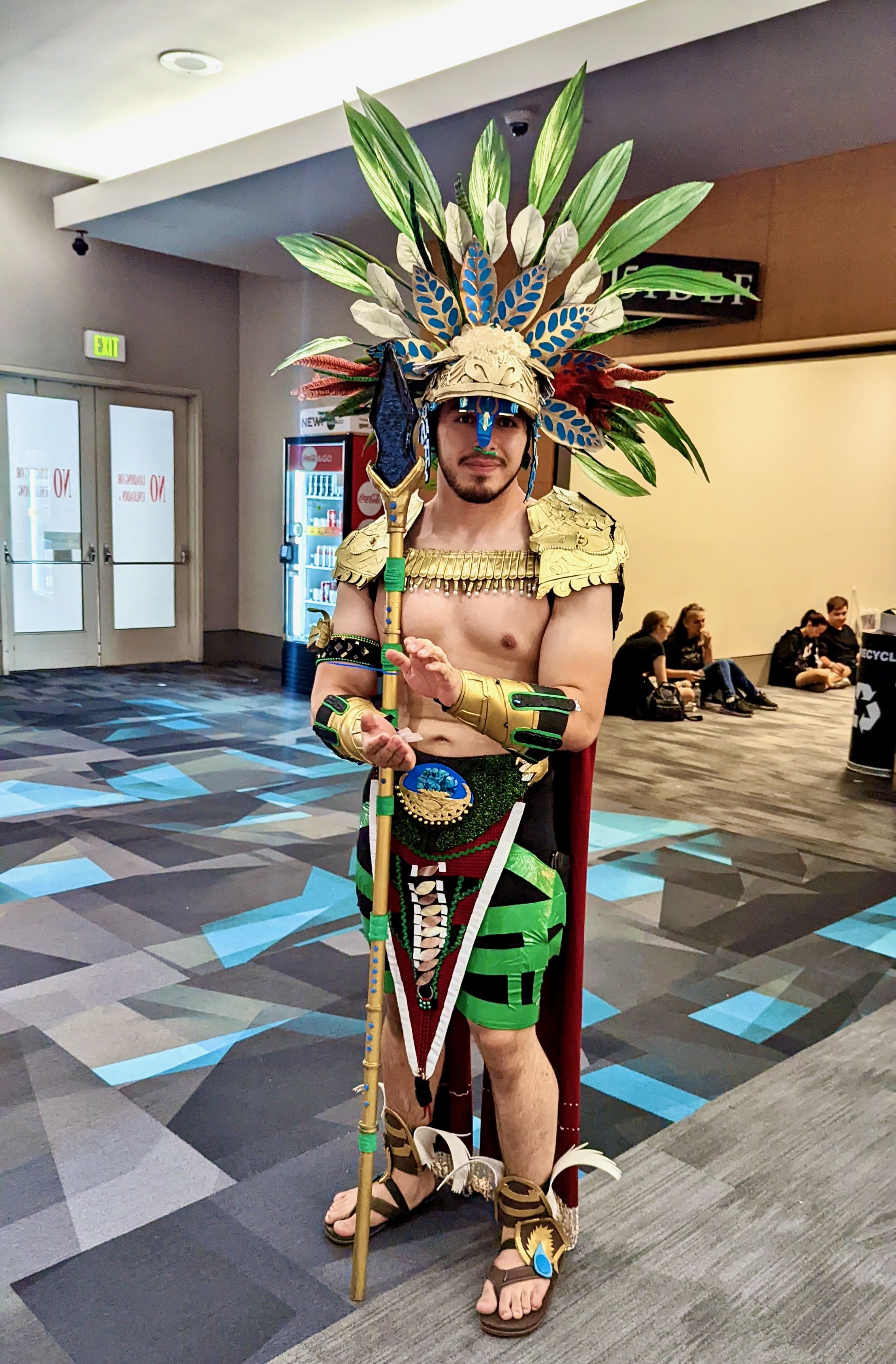 A man in a Black Panther costume in a hall.