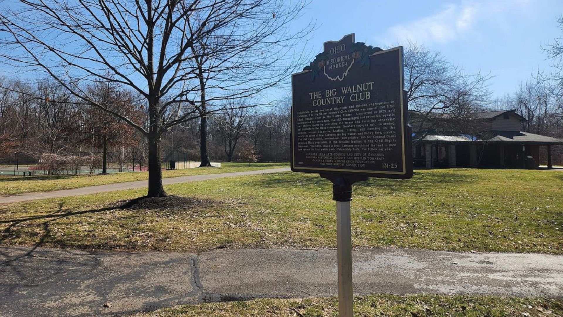 An historical marker of Big Walnut Country Club located in a park.
