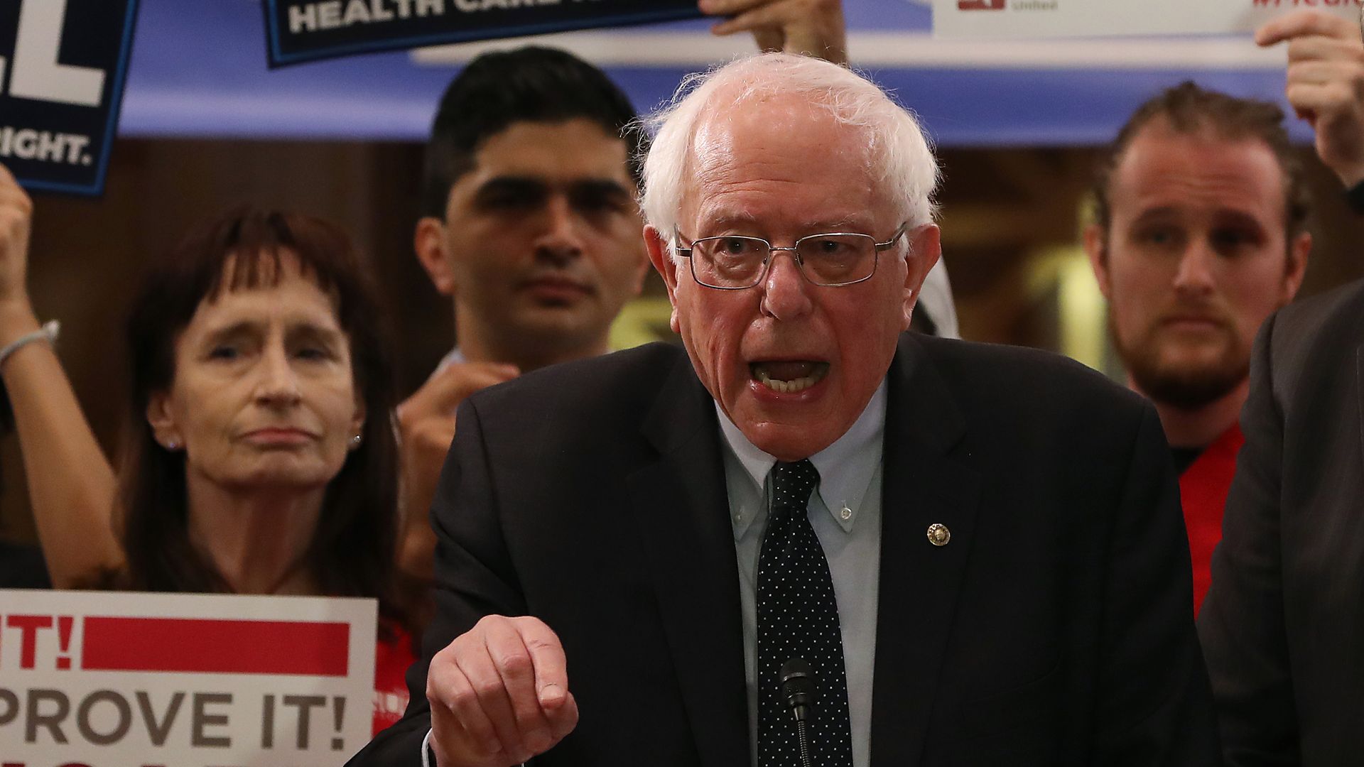 Bernie sanders at a rally yelling