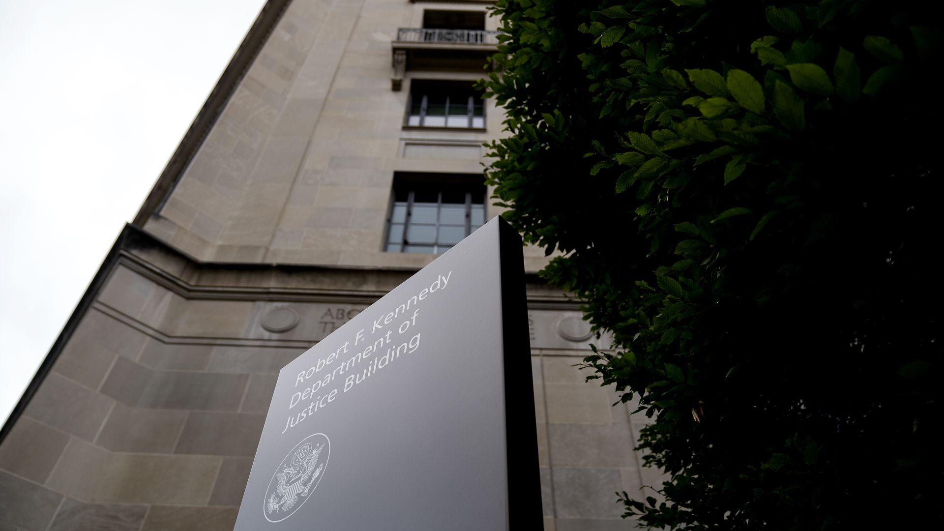 Photo of a sign that says "Robert F. Kennedy Department of Justice Building" outside the DOJ building