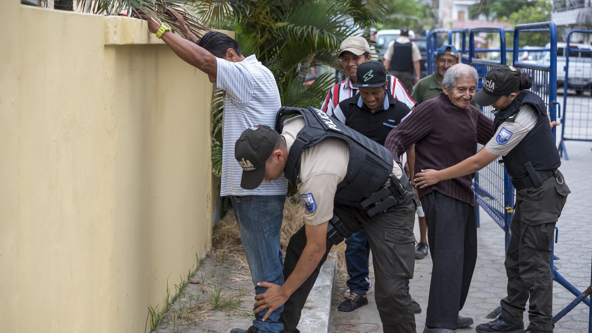 A man in protective gear pats dow voters