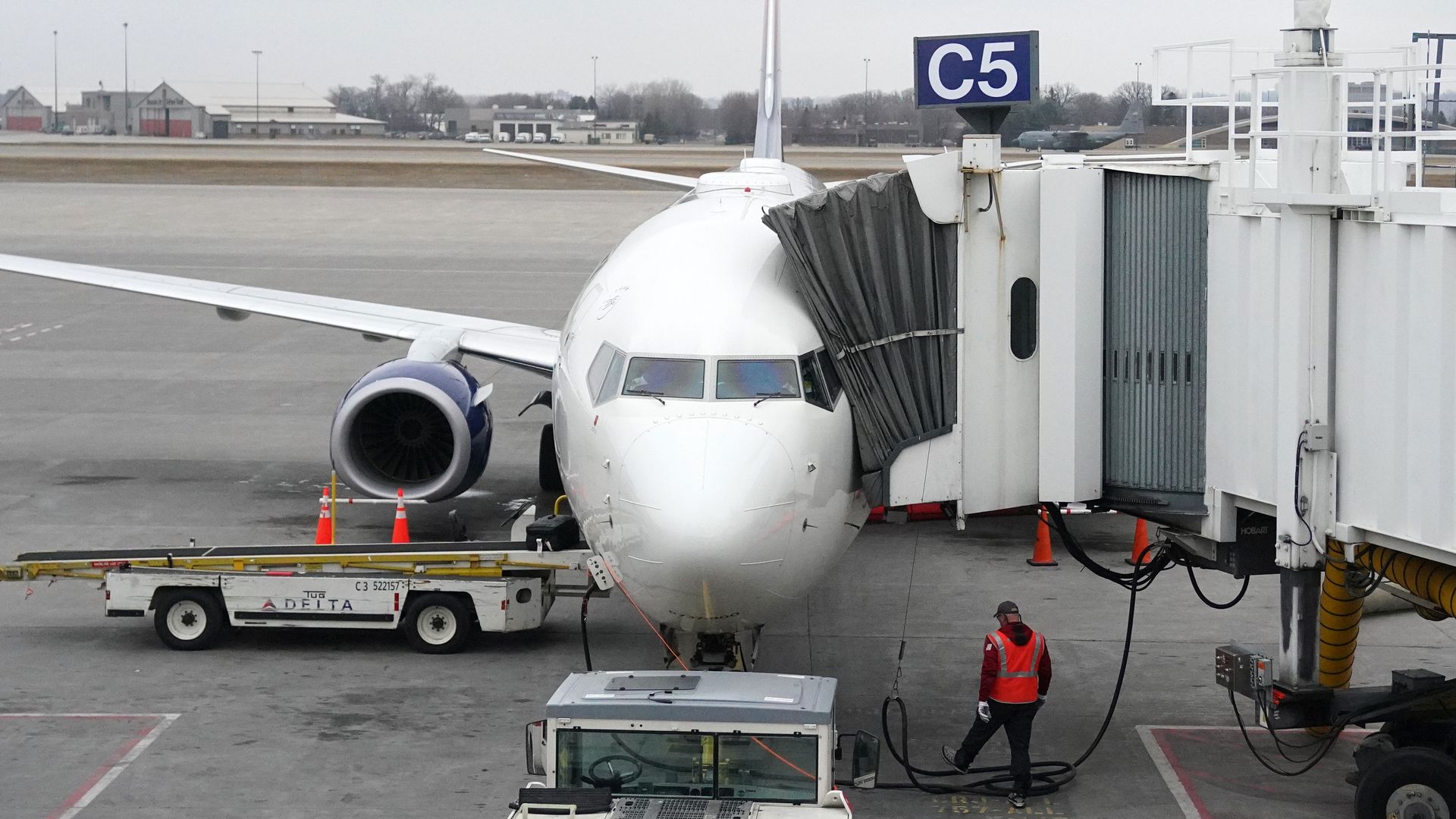 A jet at MSP airport as seen from its nose, with passengers getting on