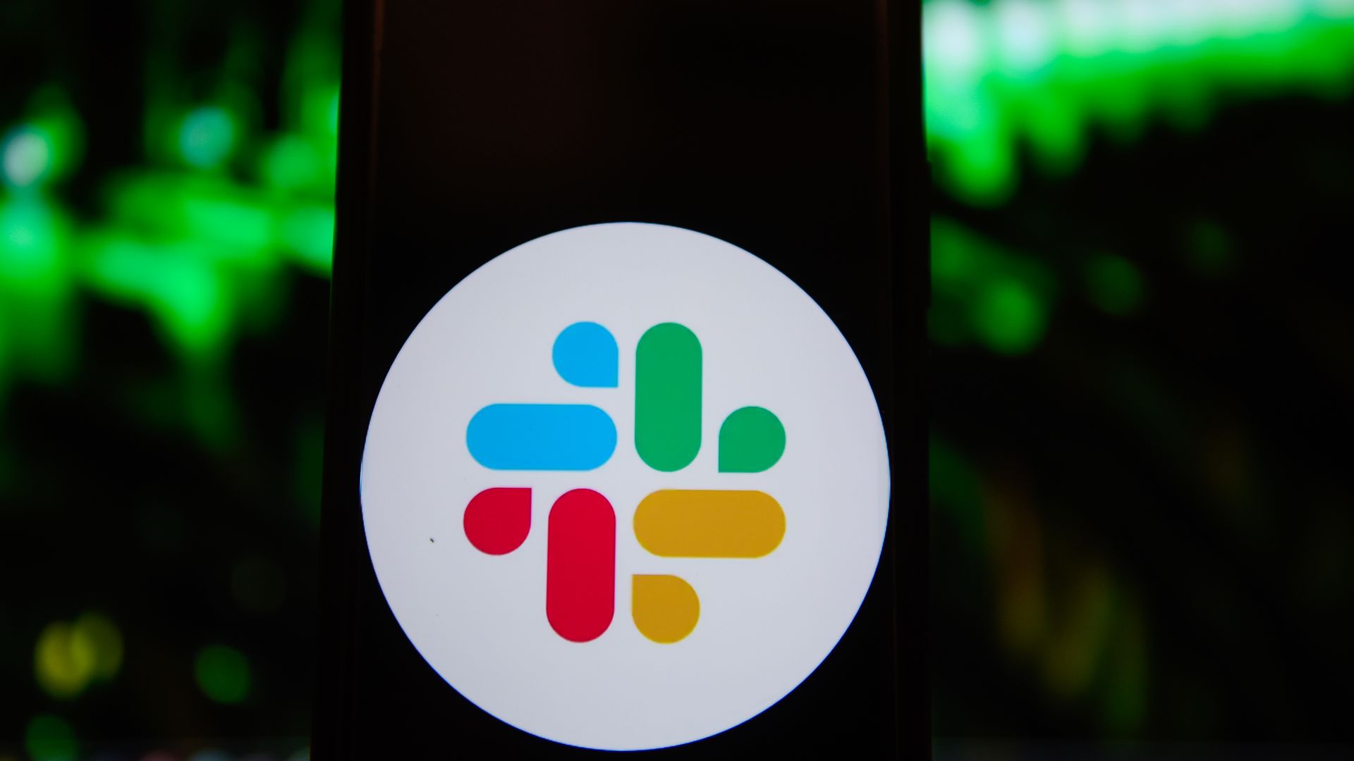 Photo illustration of a Slack logo displayed on a smartphone screen