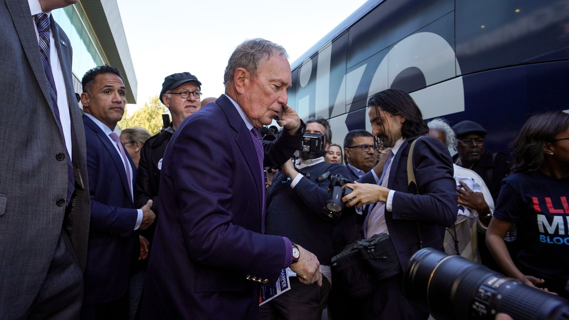 Mike Bloomberg walks near his campaign bus in Compton