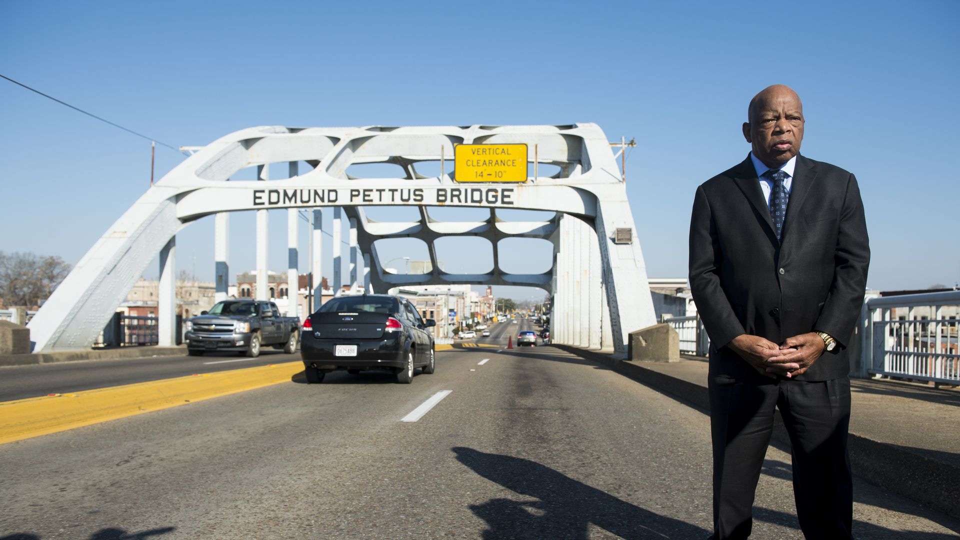 U.S. Rep. John Lewis, D-Ga., who died in 2020, stands on the Edmund Pettus Bridge in Selma, Ala., in between television interviews on Feb. 14, 2015.