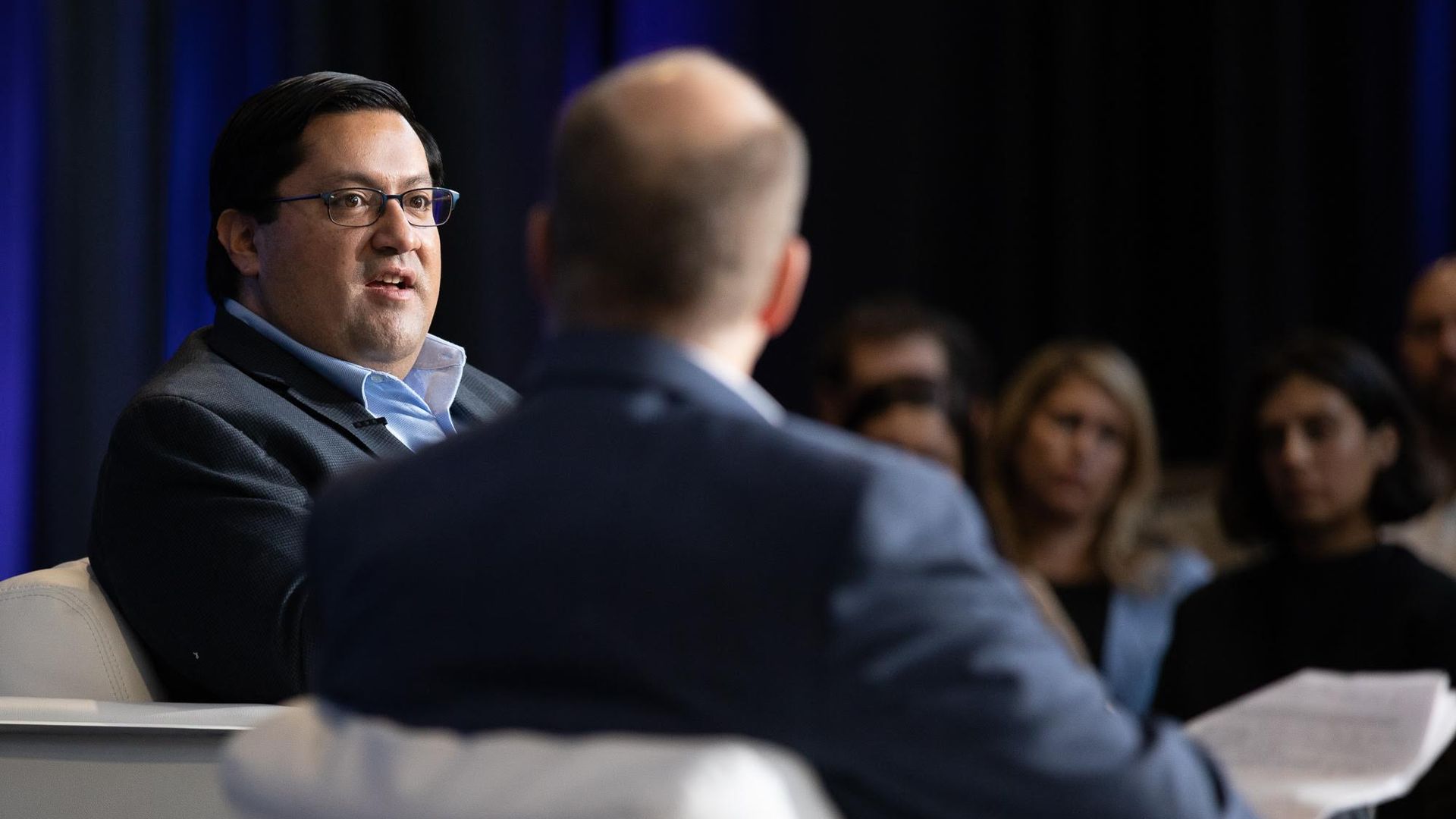 Berkeley Mayor Jesse Arreguín sitting on stage with Axios' Mike Allen. 