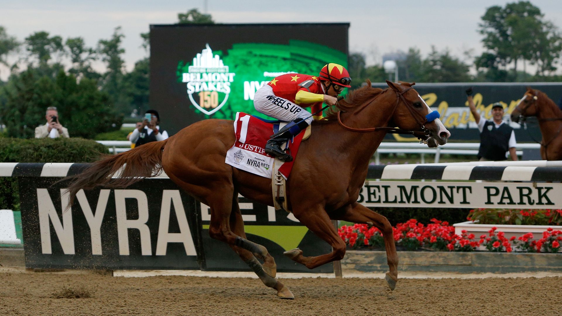 : Justify #1, ridden by jockey Mike Smith leads the field to the finish line to win the 150th running of the Belmont Stakes at Belmont Park on June 9, 2018 in Elmont, New York.