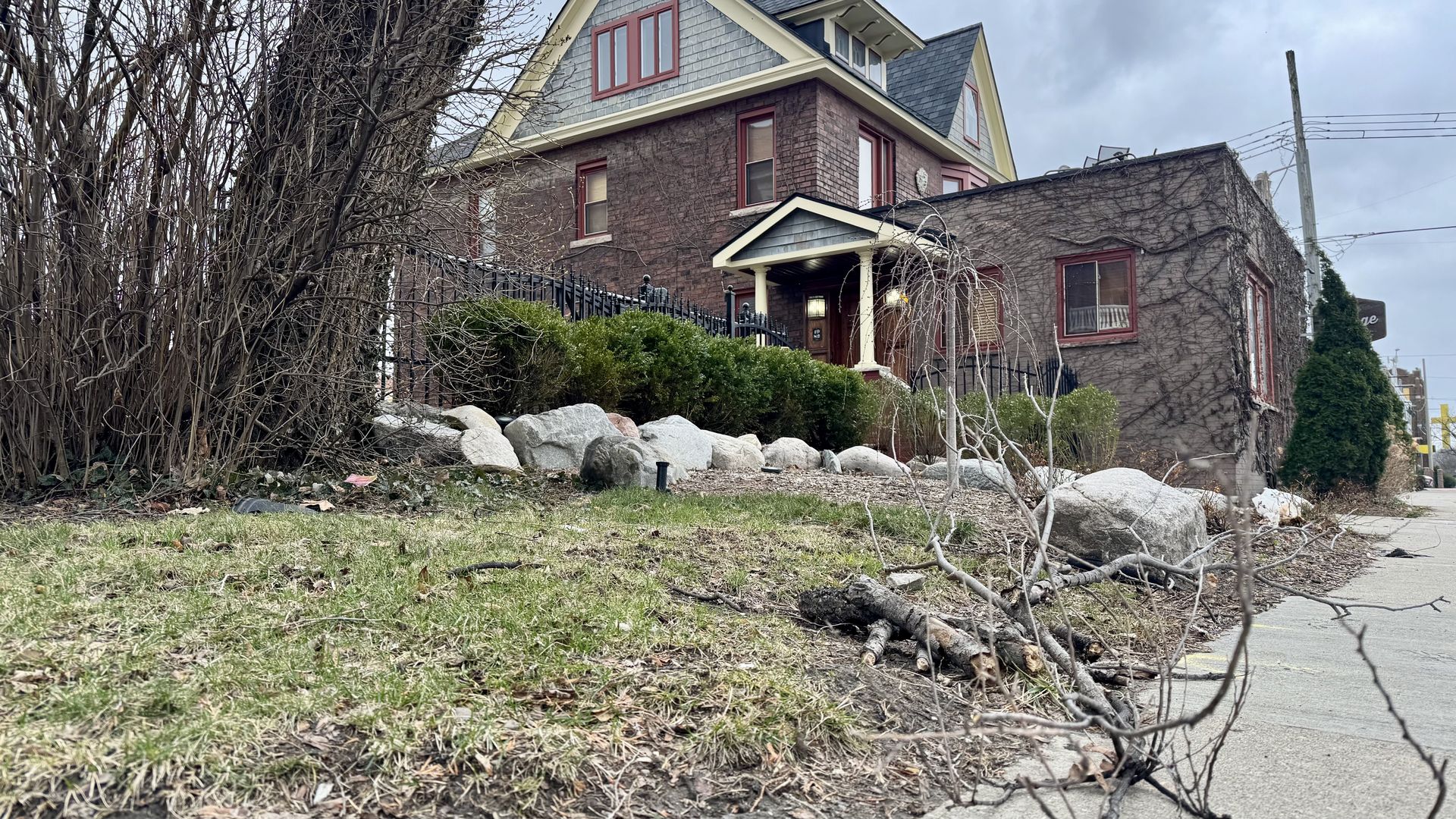 Some sticks on the ground in front of a brick building