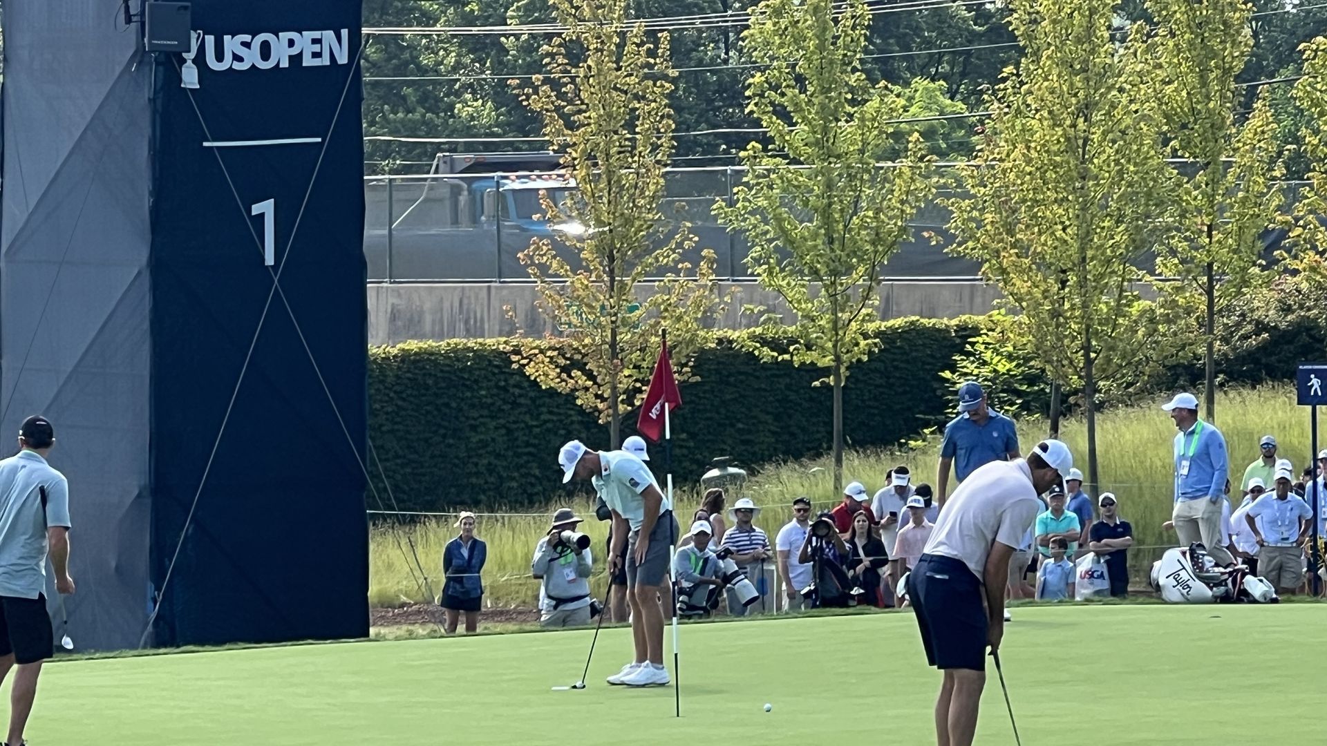 Sam burns (turquoise ) on left and Scottie Scheffler  (pink, on the right) on 1st green during a practice round at the Oakmont Country Club on Tuesday, June 10