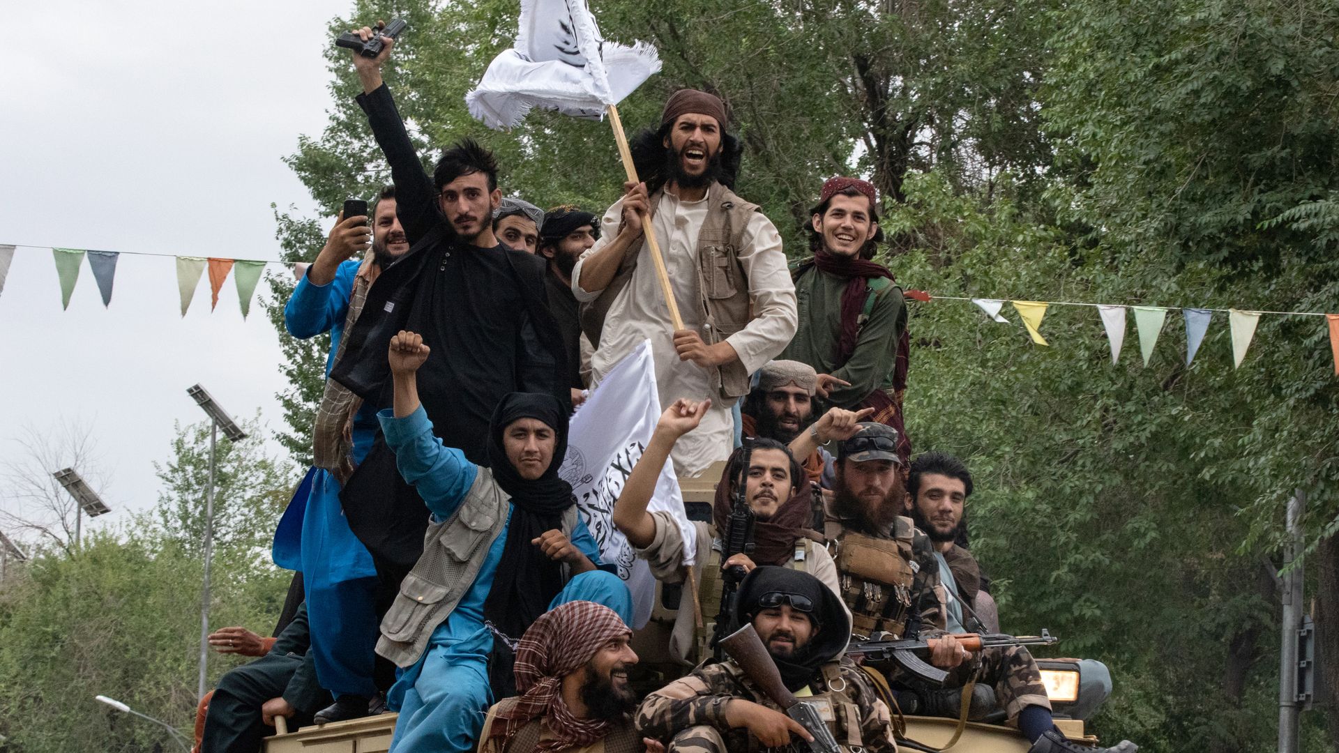 Taliban in an armored vehicle celebrating