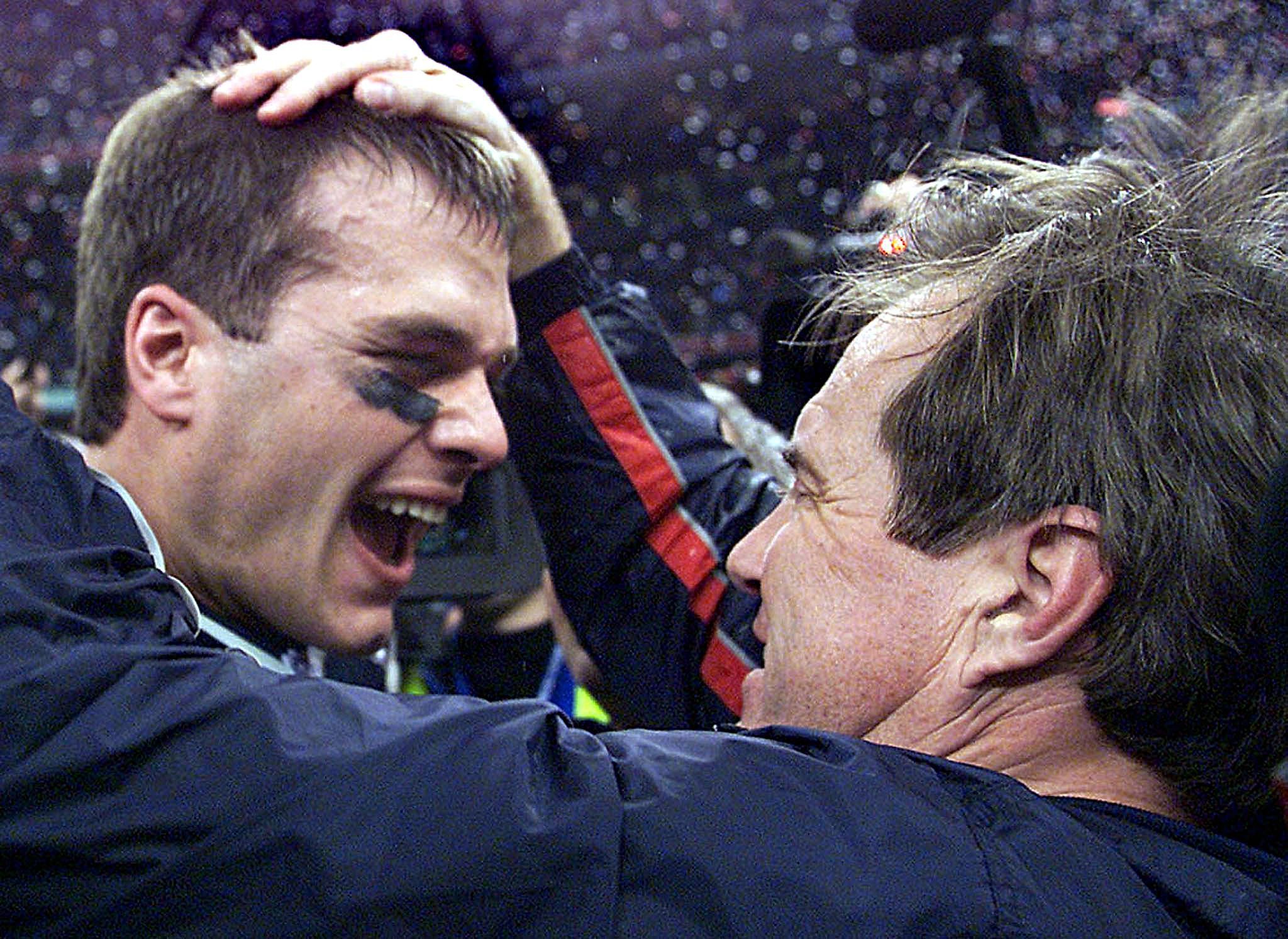 Tom Brady and Bill Bellichick embrace after winning their first Super Bowl together in 2002.