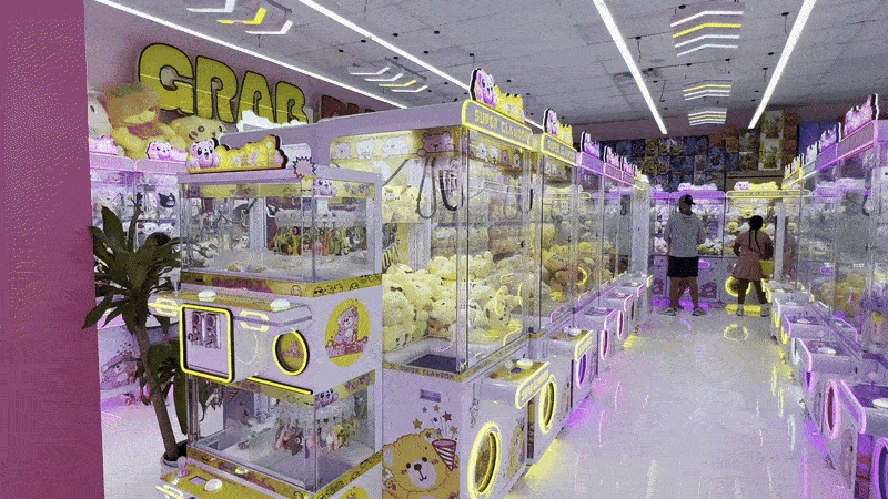 Image shows a claw machine arcade with people in it
