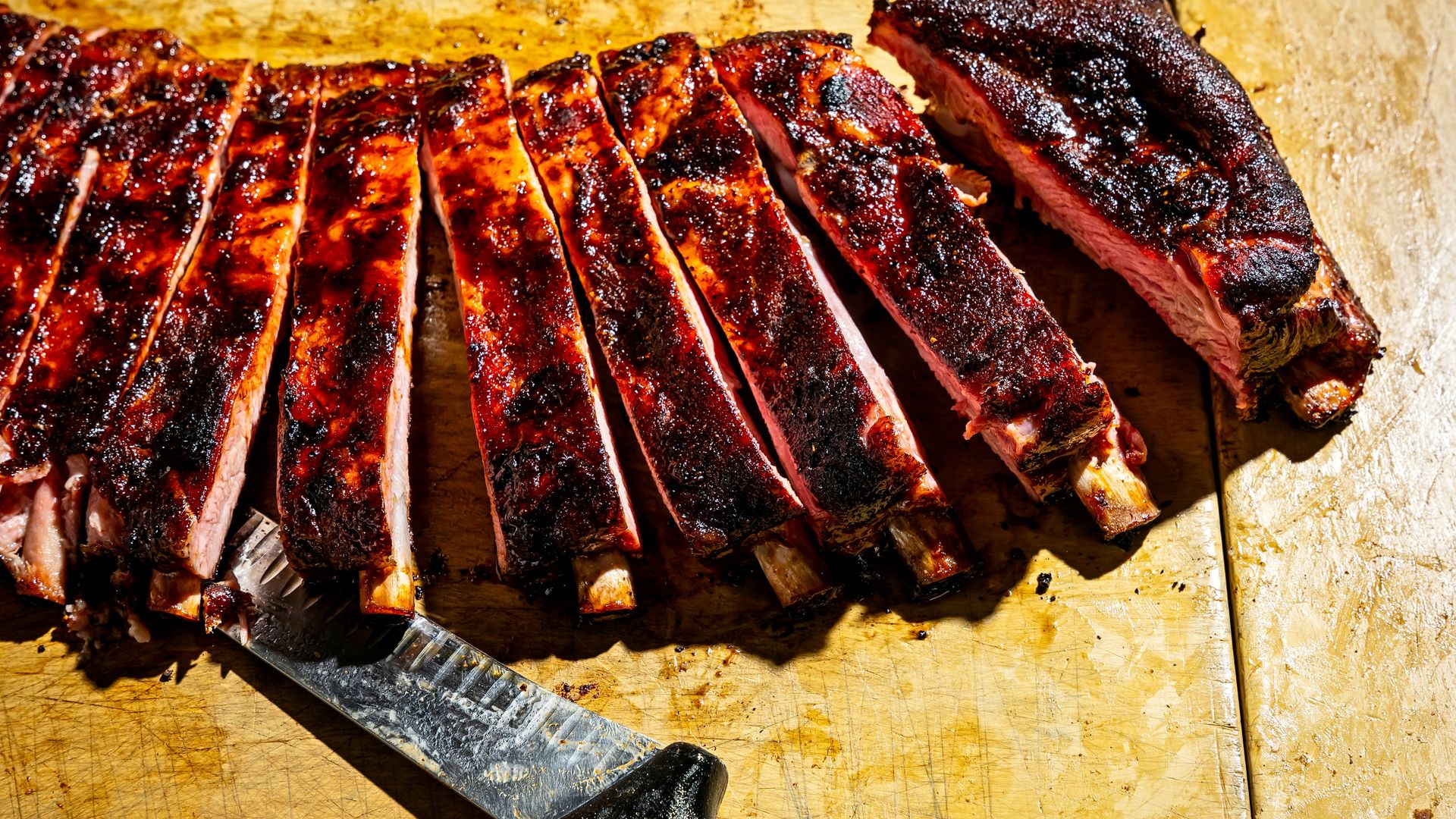 A rack of ribs being sliced