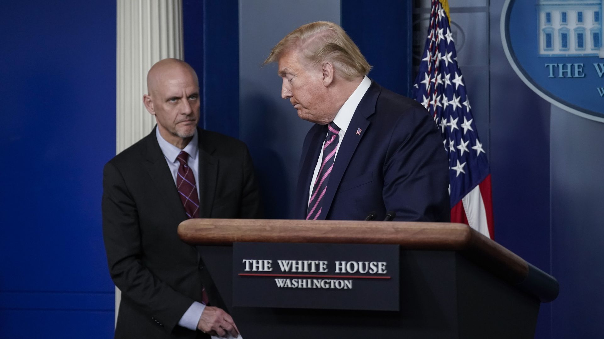 In this image, Trump stands behind a White House podium