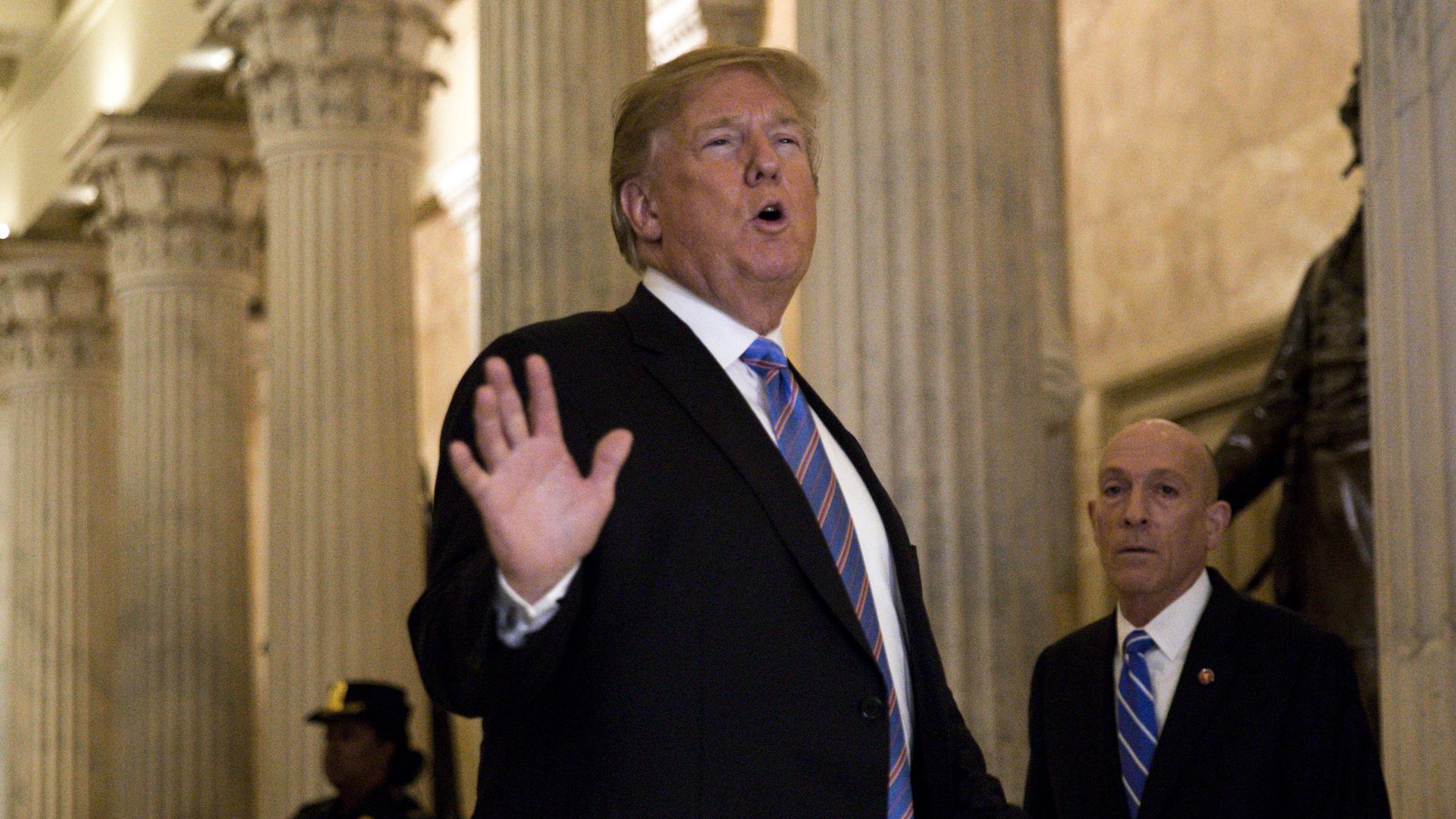 President Trump gestures while chatting on Capitol Hill