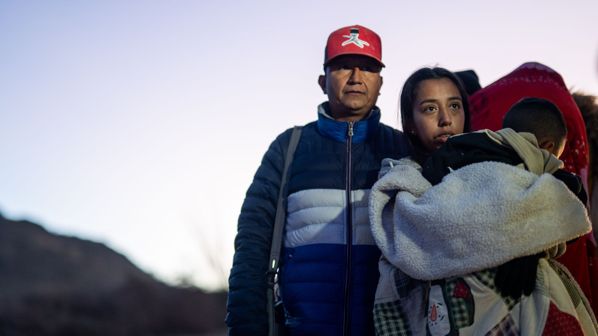 Mexican migrants, Laura Elizabeth and her son, Matias, turn themselves in to U.S. Customs and Border Patrol officers after crossing over a section of border wall into the U.S. in Ruby, Arizona. 