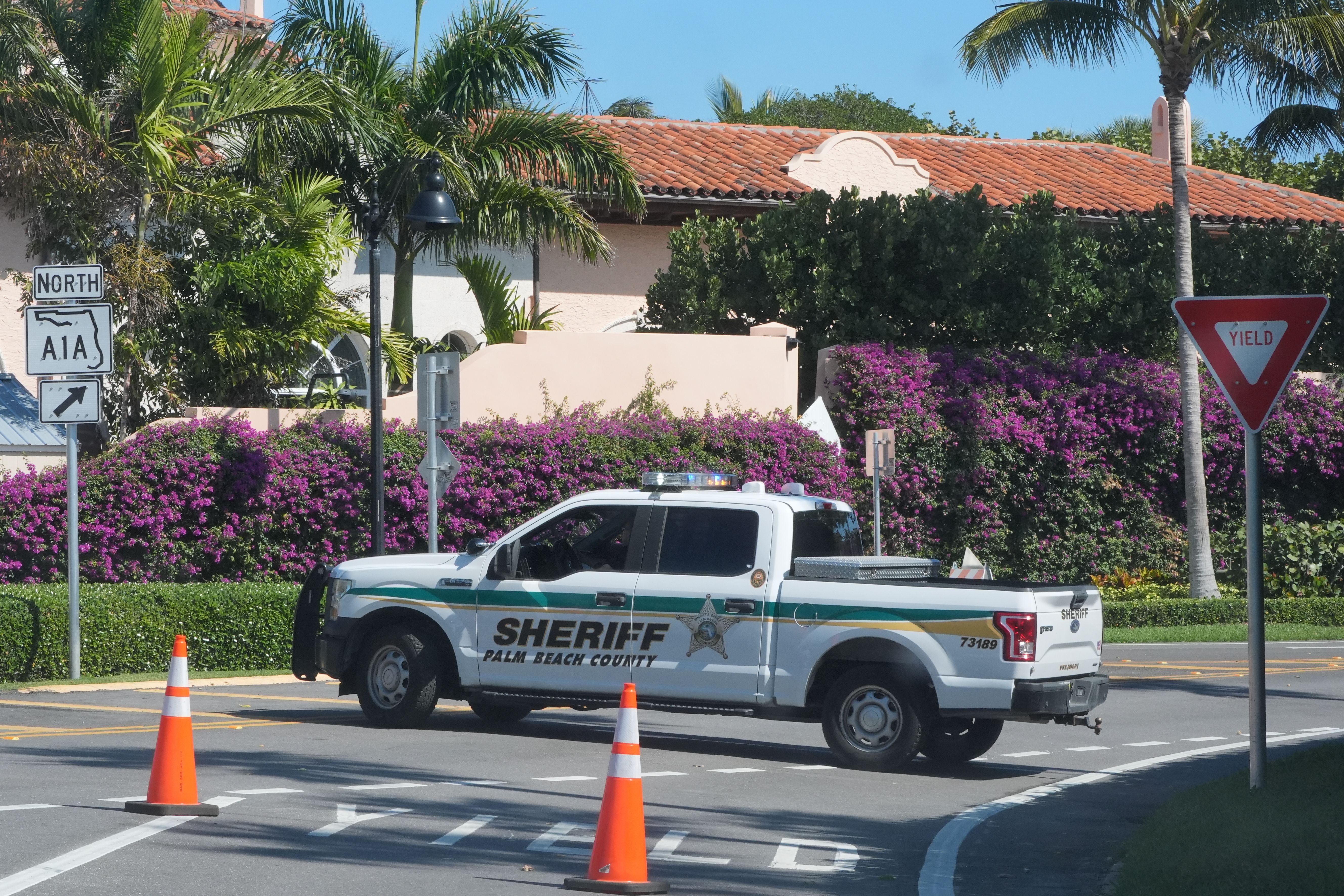 A Palm Beach County Sheriff's vehicle blocks traffic near Mar-a-Lago yesterday.