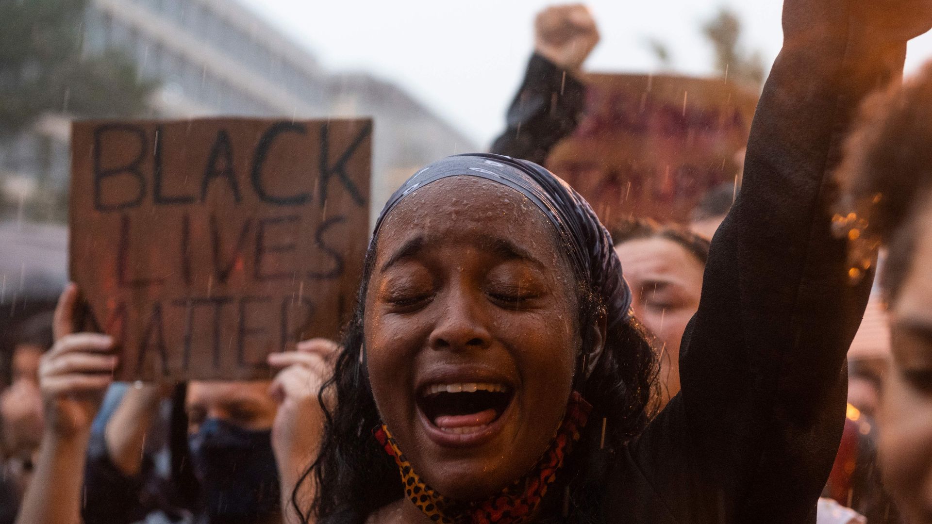 A protester shouts "Black Lives Matter" during a rain storm in front of Lafayette Park next to the White House, Washington, DC