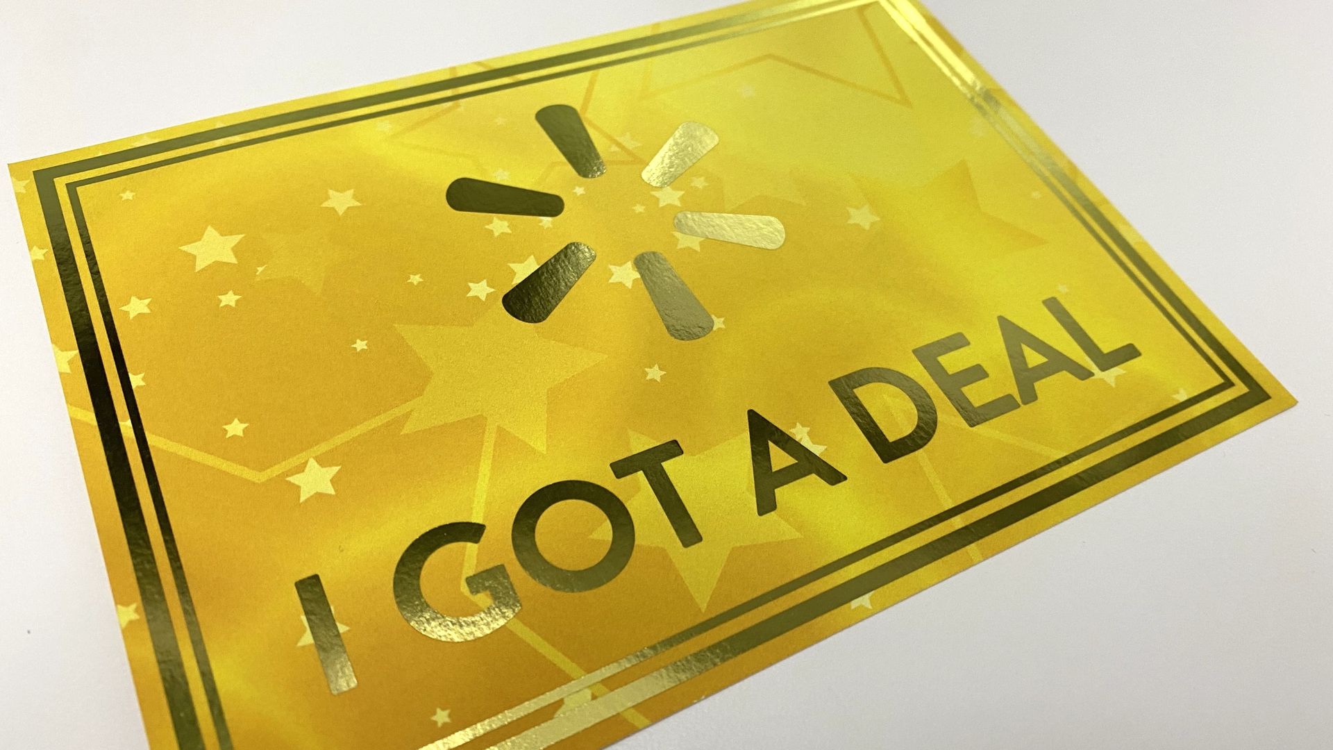 A photo of a golden piece of paper reading "I got a deal" with the Walmart logo. 