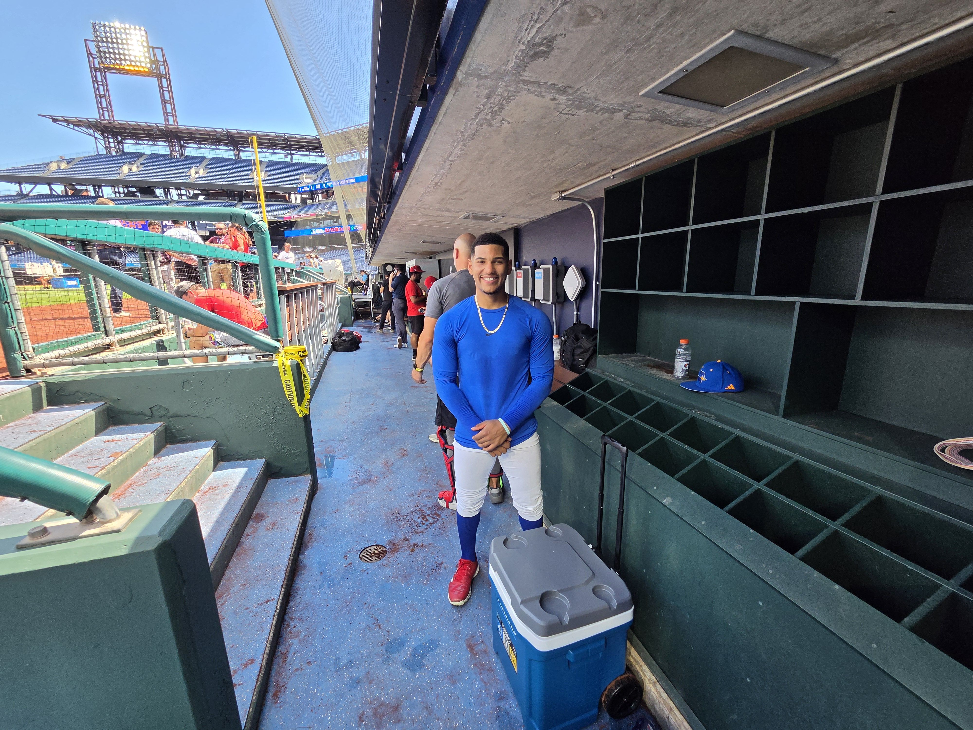 College baseball player Steve Frias posing for a photo in the Phillies dugout.