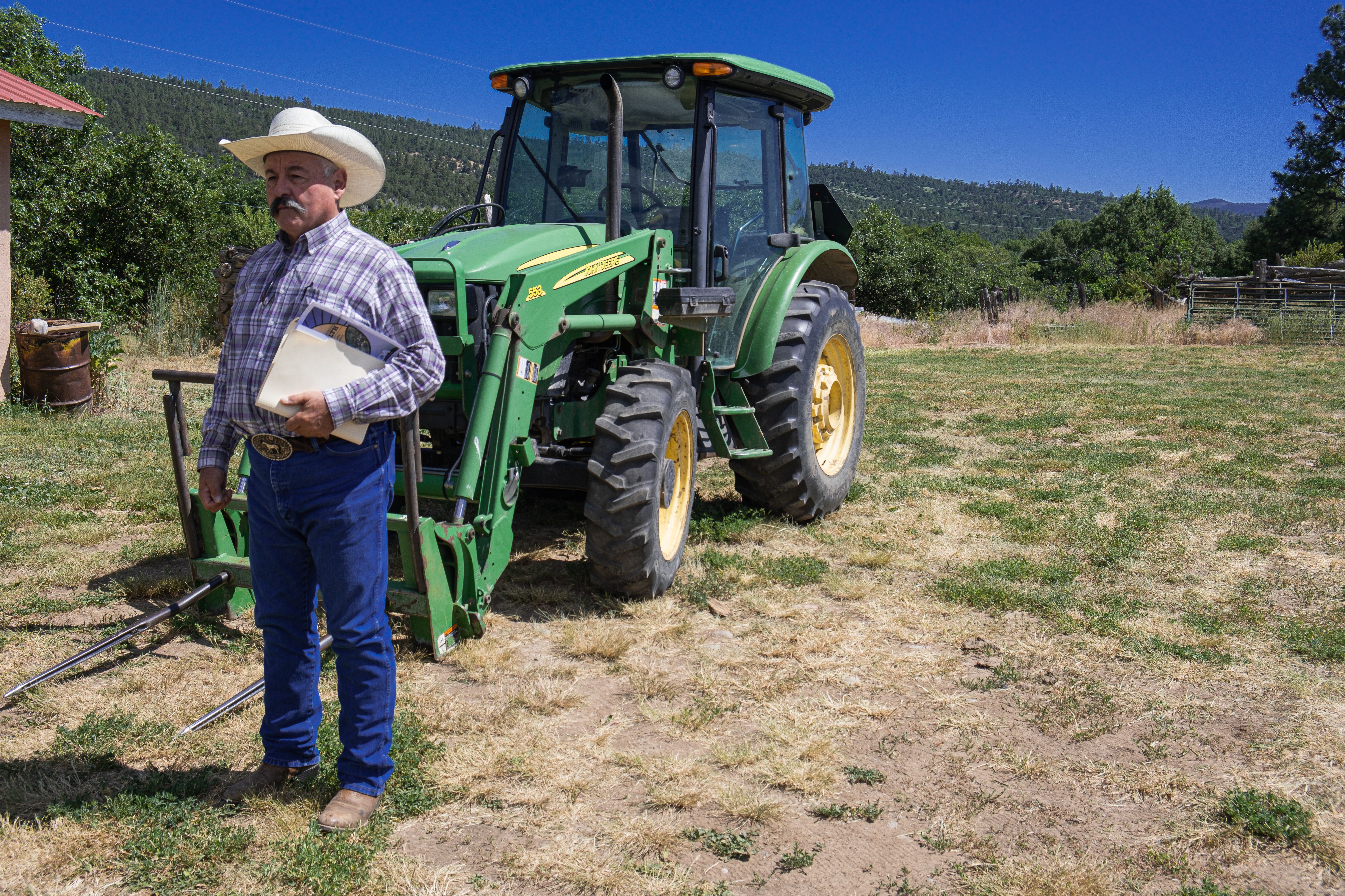 New Mexico rancher David Sanchez in Canjilon, New Mexico, in front of a tractor.