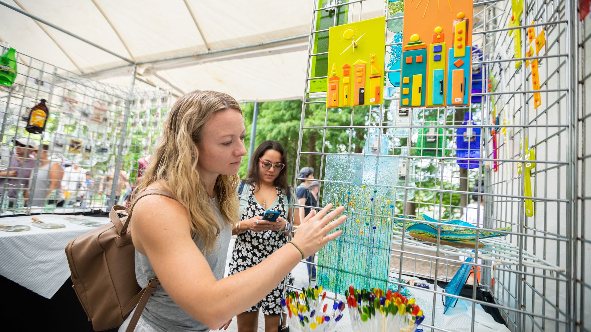 A shopper browses vendors at the Piedmont Park Arts Festival.