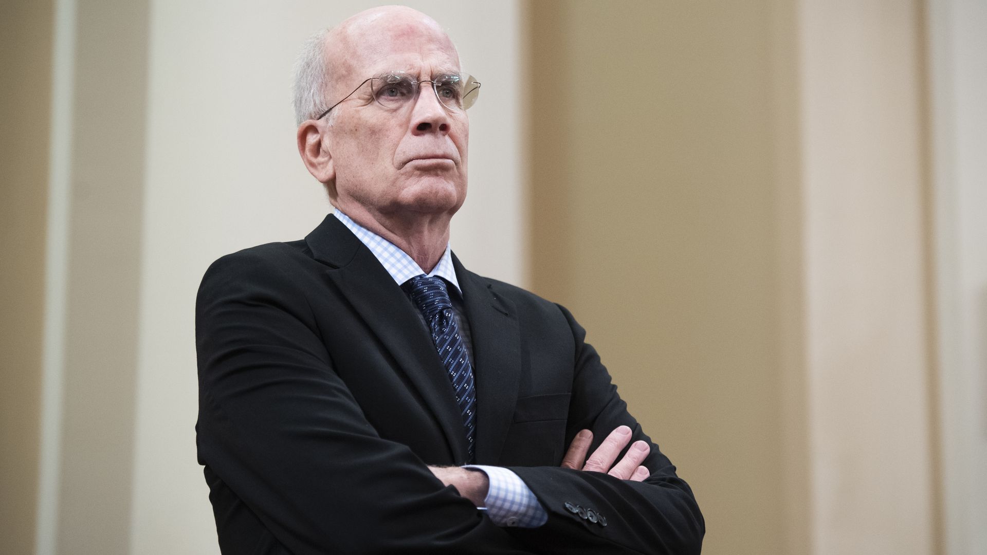 Rep. Peter Welch is seen standing, with his arms crossed.