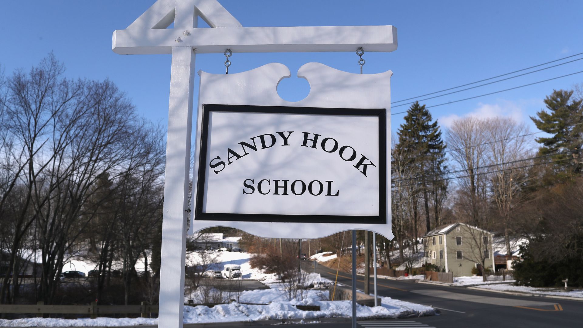 A sign marks the entrance to the Sandy Hook Elementary School, where 26 teachers and students were shot and killed eight years ago Monday.